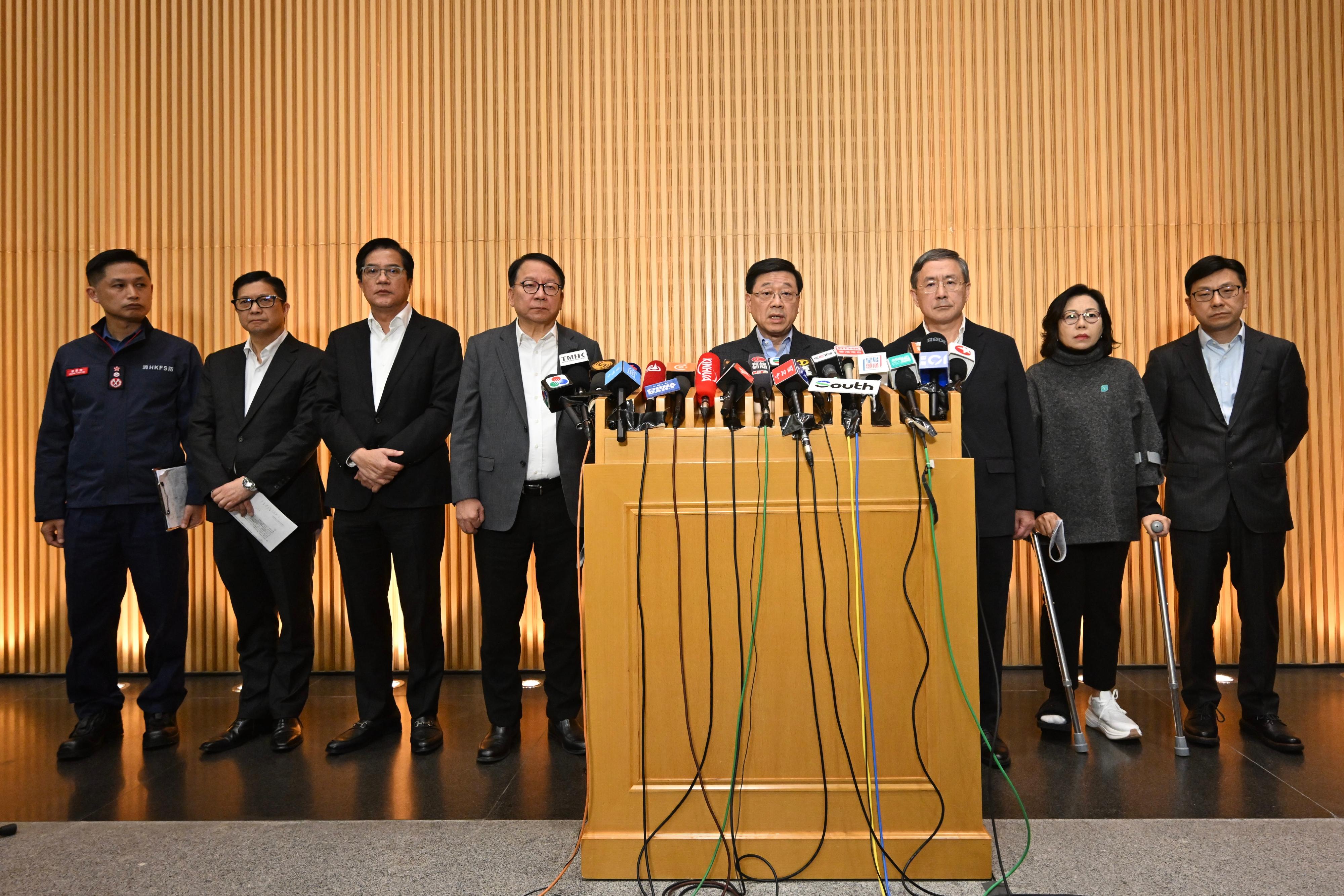 The Chief Executive, Mr John Lee (fourth right), meets the media together with the Chief Secretary for Administration, Mr Chan Kwok-ki (fourth left); the Deputy Chief Secretary for Administration, Mr Cheuk Wing-hing (third right); the Deputy Financial Secretary, Mr Michael Wong (third left); the Secretary for Security, Mr Tang Ping-keung (second left); the Secretary for Home and Youth Affairs, Miss Alice Mak (second right); the Secretary for Labour and Welfare, Mr Chris Sun (first right); and the Director of Fire Services, Mr Andy Yeung (first left), on the follow-up work of the No. 5 alarm fire at Wang Fuk Court in Tai Po today (November 27).