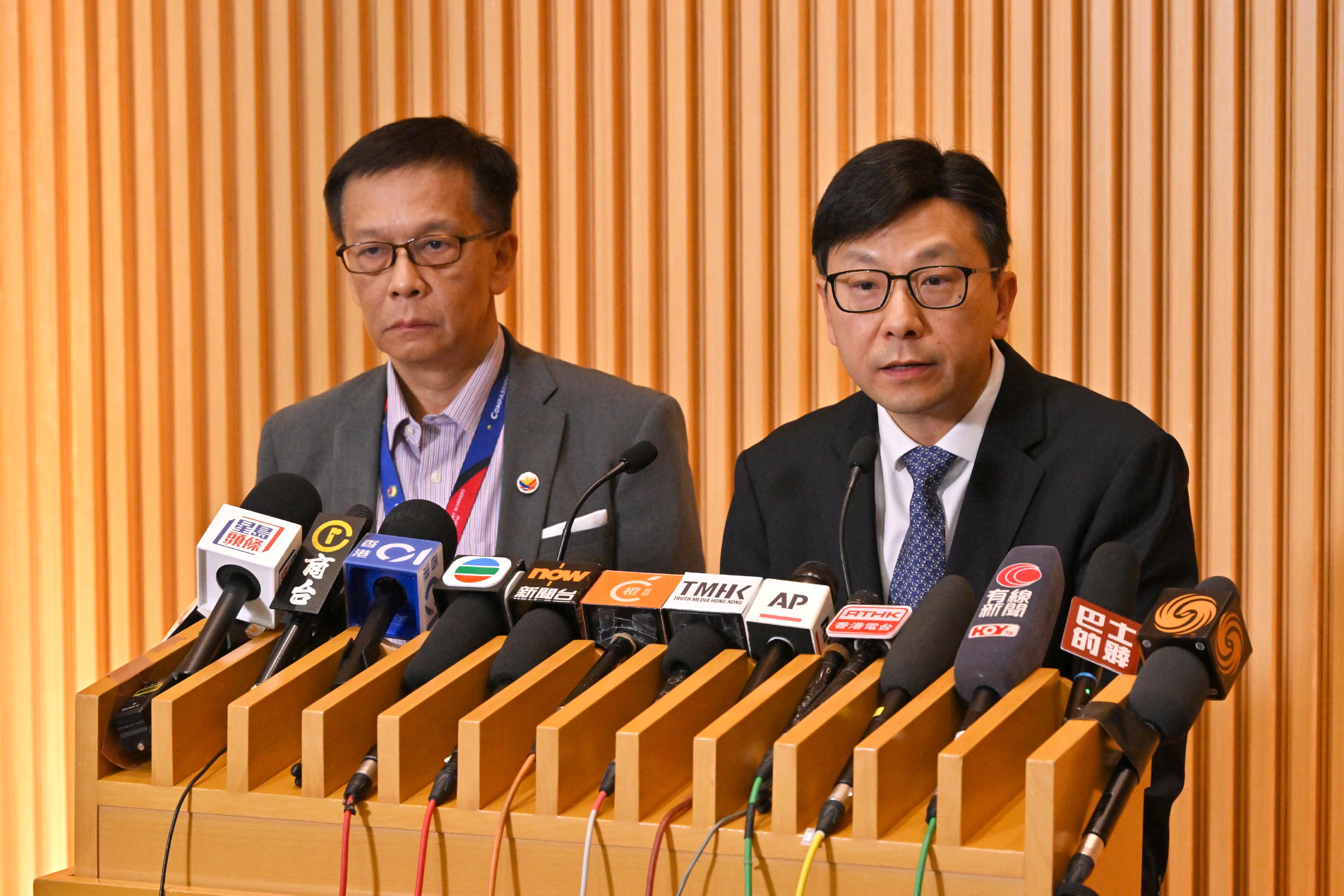 The Secretary for Labour and Welfare, Mr Chris Sun (right), meets the media today (December 2) together with the Secretary for Migrant Workers of the Philippines, Mr Hans Leo J. Cacdac (left), on the follow-up work on the  fire at Wang Fuk Court in Tai Po.