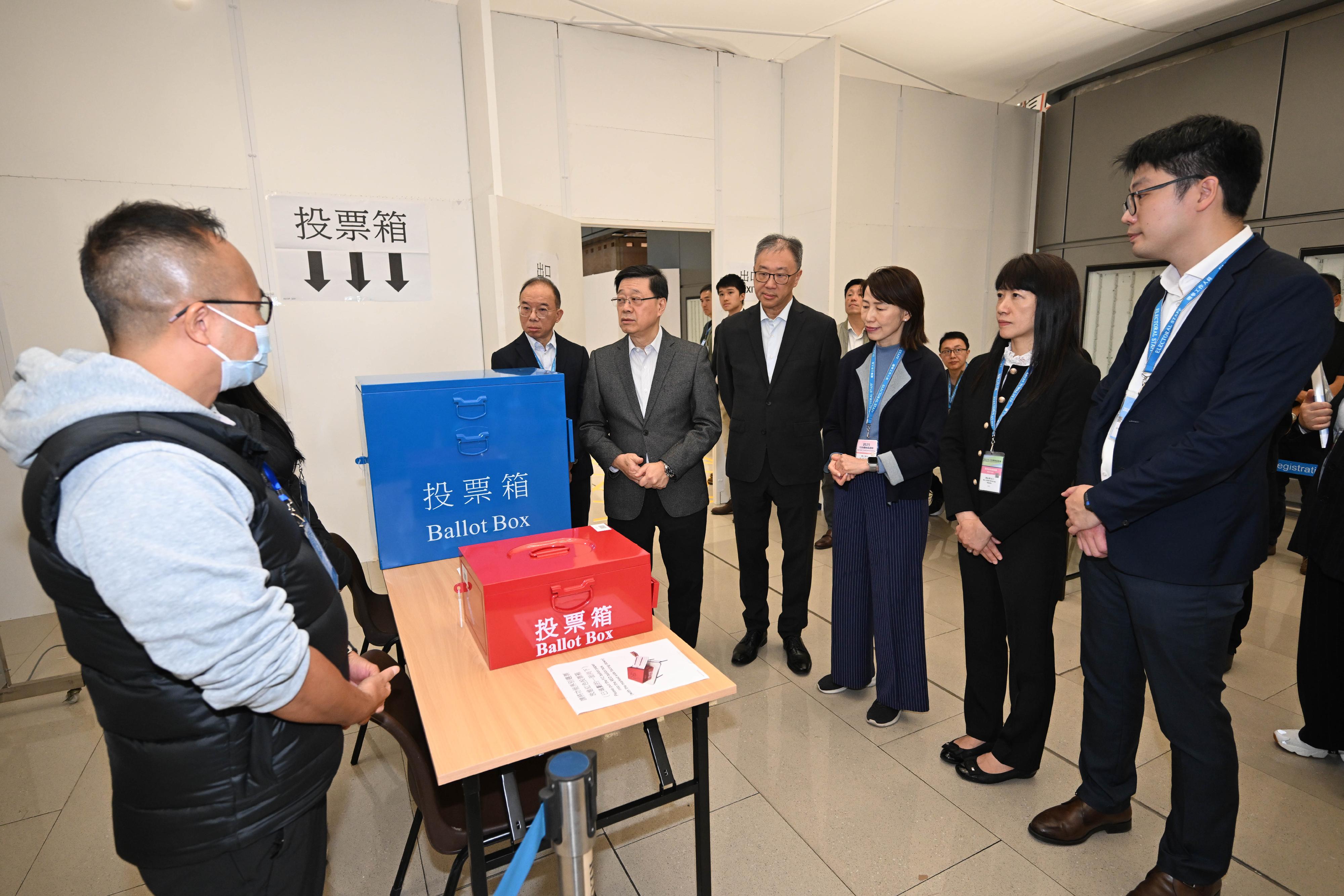 The Chairman of the Electoral Affairs Commission, Mr Justice David Lok (third left); the Secretary for Constitutional and Mainland Affairs, Mr Erick Tsang Kwok-wai (first left); the Director of the Chief Executive's Office, Ms Carol Yip (third right); and the Chief Electoral Officer of the Registration and Electoral Office, Ms Natalie Chan (second right), accompany the Chief Executive, Mr John Lee (second left), to visit the Near Boundary Polling Station of the 2025 Legislative Council General Election at Hong Kong-Zhuhai-Macao Bridge Hong Kong Port this morning (December 6) to see for themselves the final preparatory work including the set-up of the venue and rehearsals.