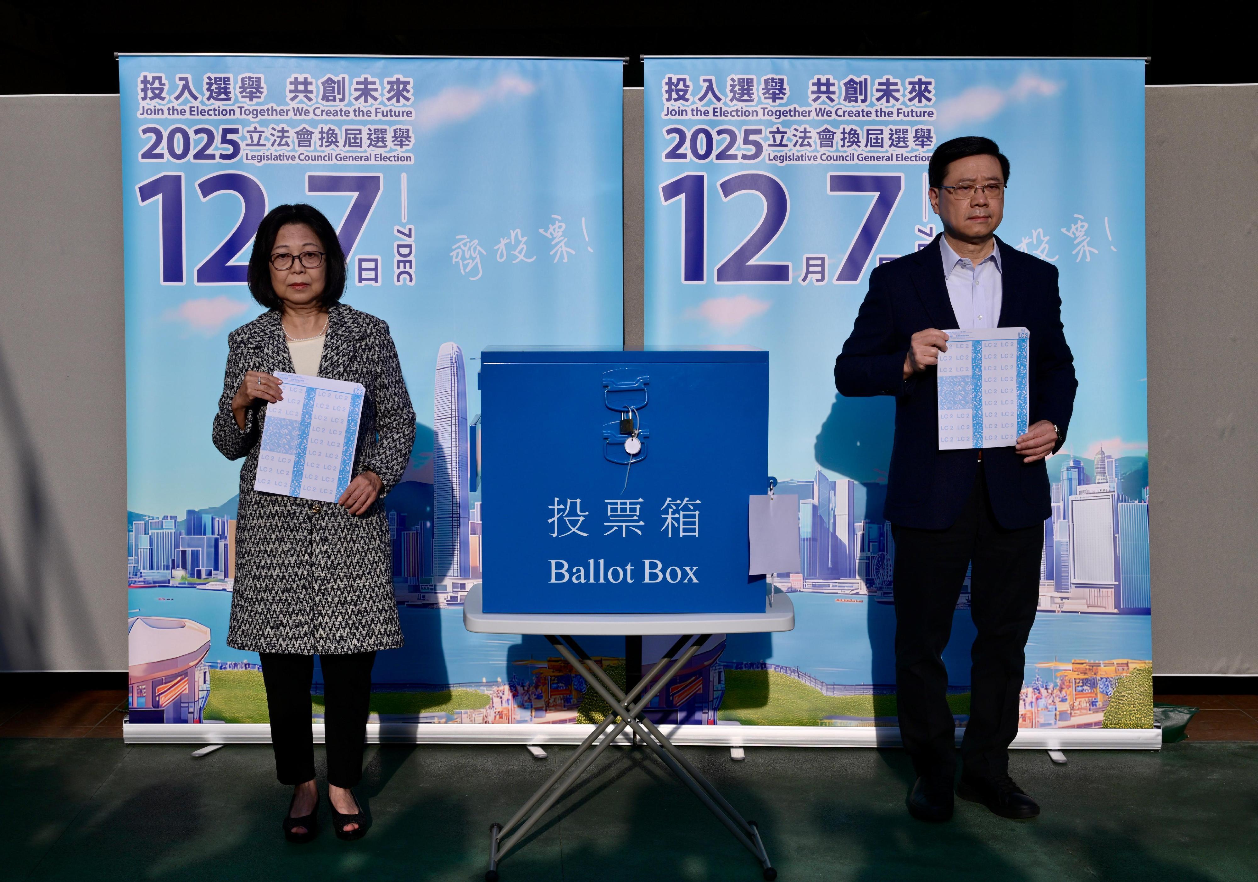 行政长官李家超(右)及其夫人(左)今日(十二月七日)上午在高主教书院为二○二五年立法会换届选举投票。