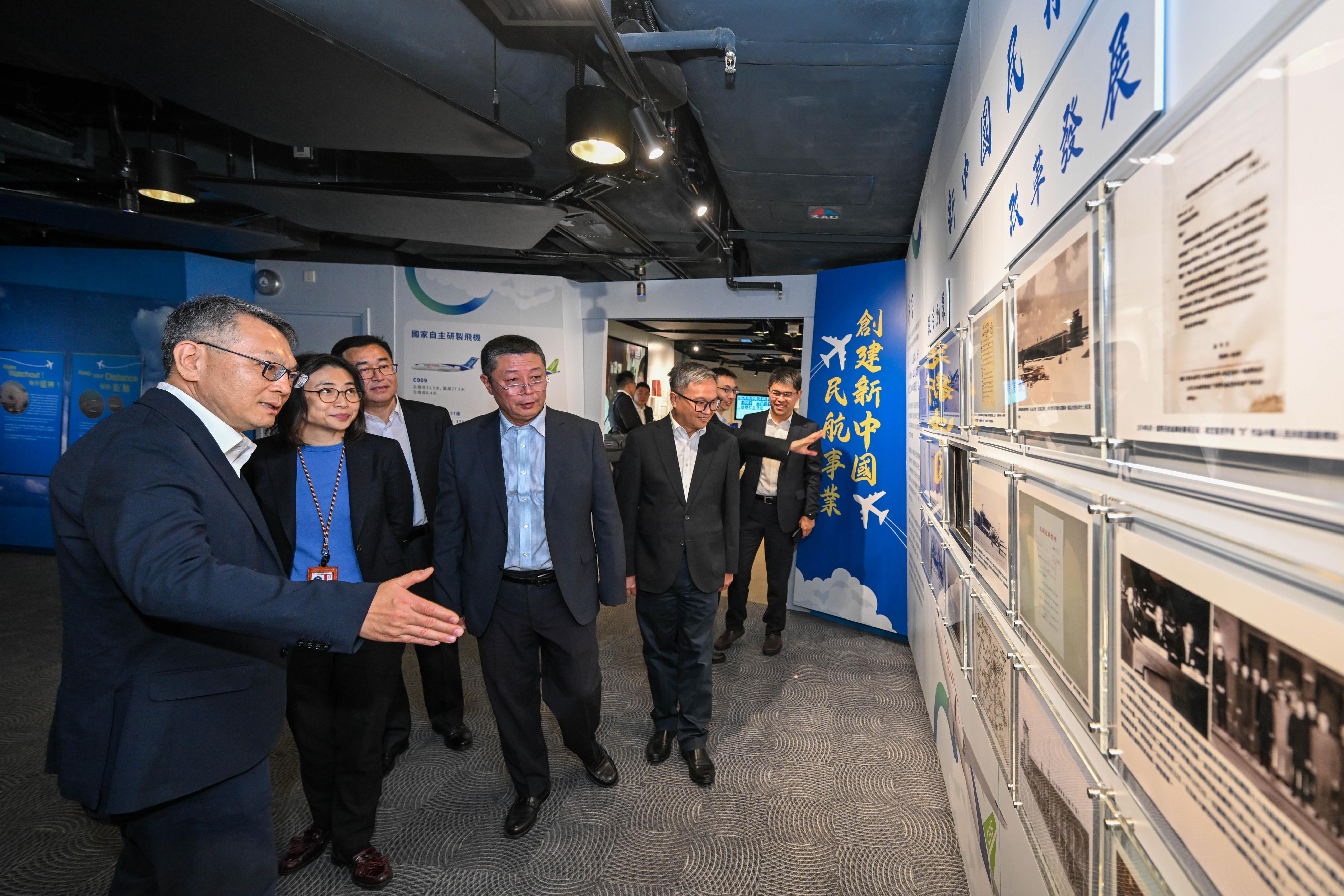 The sharing session themed "Quest for dreams, Pay tribute to the era", jointly organised by the Central and Southern Regional Administration and the Air Traffic Management Bureau of the Civil Aviation Administration of China (CAAC), and the Civil Aviation Department (CAD) was held on December 9. Photo shows the Director-General of Civil Aviation, Mr Victor Liu (first left), introducing themed exhibits at the exhibition gallery on “Our Country’s Achievements in Civil Aviation Development since the founding of the People's Republic of China” set up at the CAD Aviation Education Path. Joining the tour was the Deputy Administrator of the CAAC, Mr Ma Bing (fourth left).