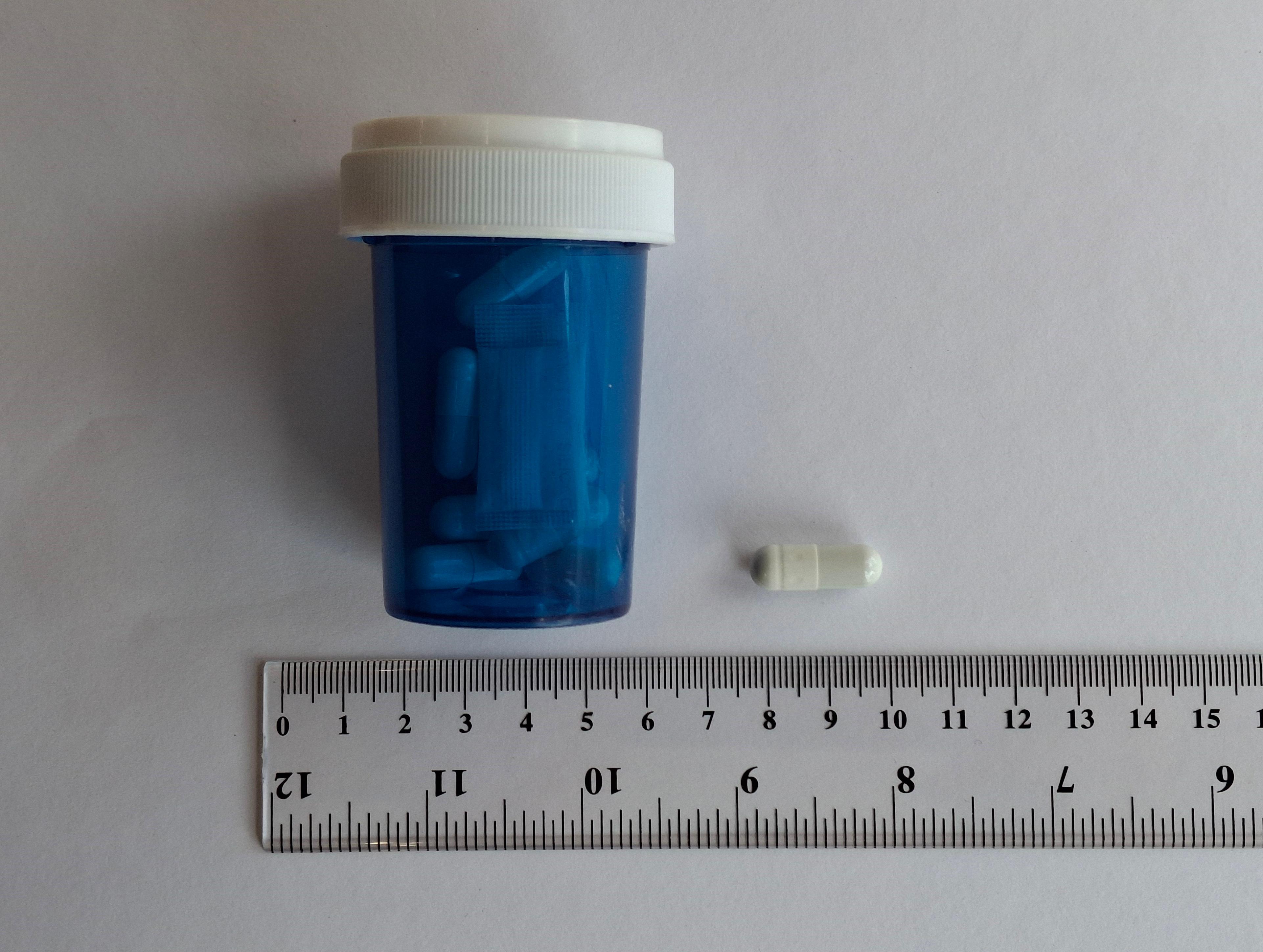In response to suspected illegal sales of slimming products containing banned and undeclared controlled drug ingredients on social media platforms, the Department of Health today (December 11) carried out enforcement operations in Tseung Kwan O and Tai Po with the Police. Photo shows a capsule sample that was packaged in an unlabelled blue plastic container.