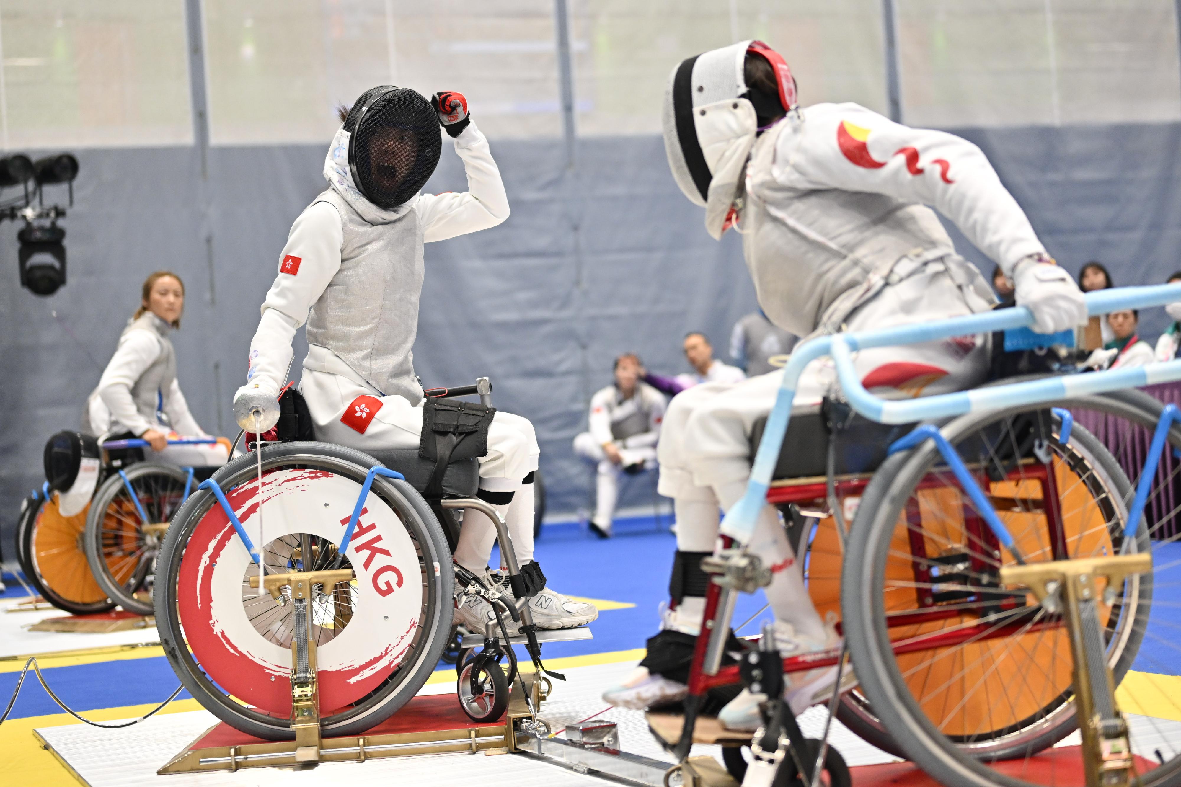 The women's foil team of the Hong Kong Jockey Club Trophy wheelchair fencing competition of the 12th National Games for Persons with Disabilities and the 9th National Special Olympic Games was held at Ma On Shan Sports Centre today (December 10). Photo shows athletes competing in the event.