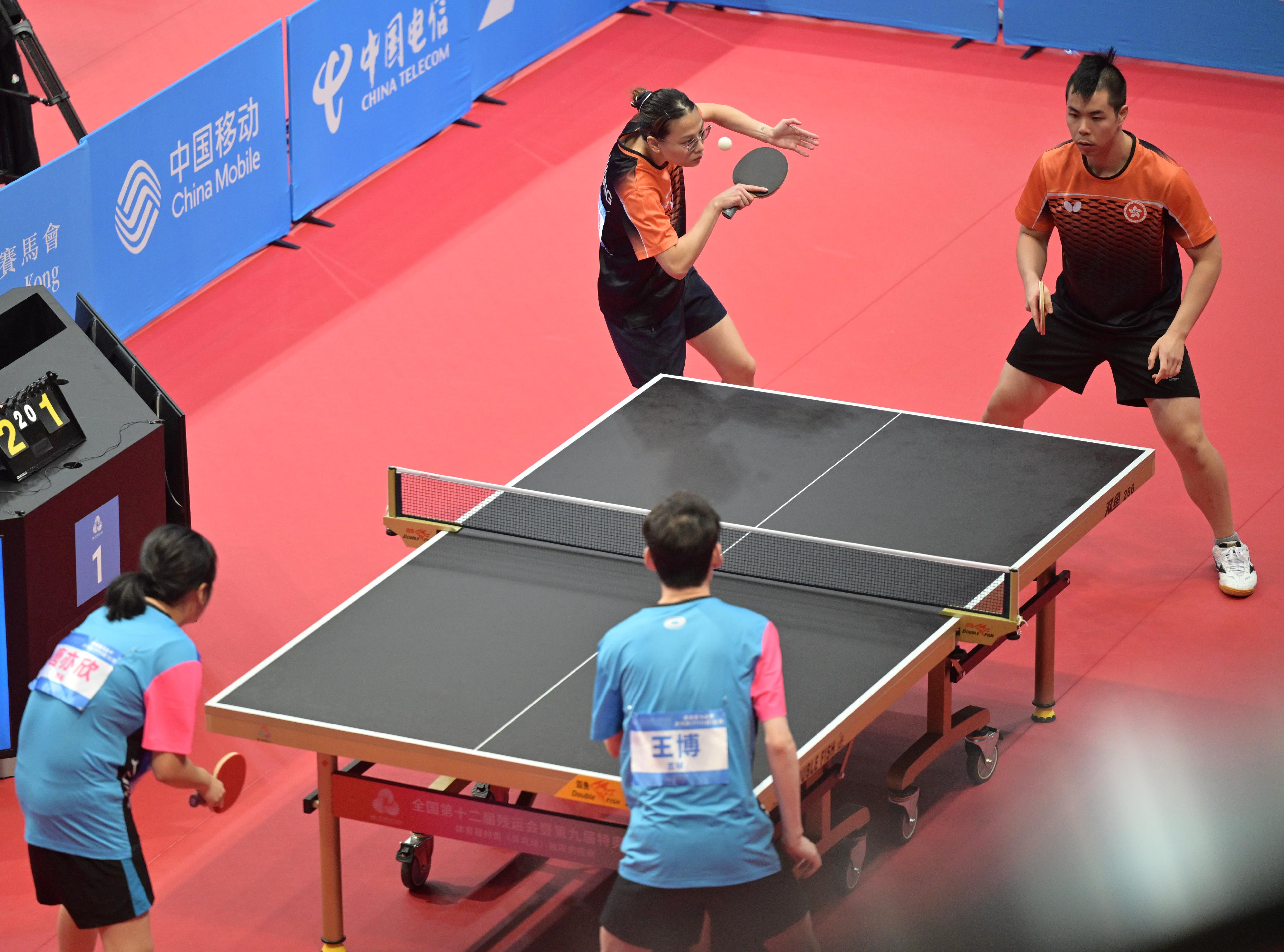The Hong Kong Jockey Club Trophy para table tennis (TT11) competition of the 12th National Games for Persons with Disabilities and the 9th National Special Olympic Games was held today (December 13) at Tsuen Wan Sports Centre. Photo shows athletes competing in the mixed doubles event.