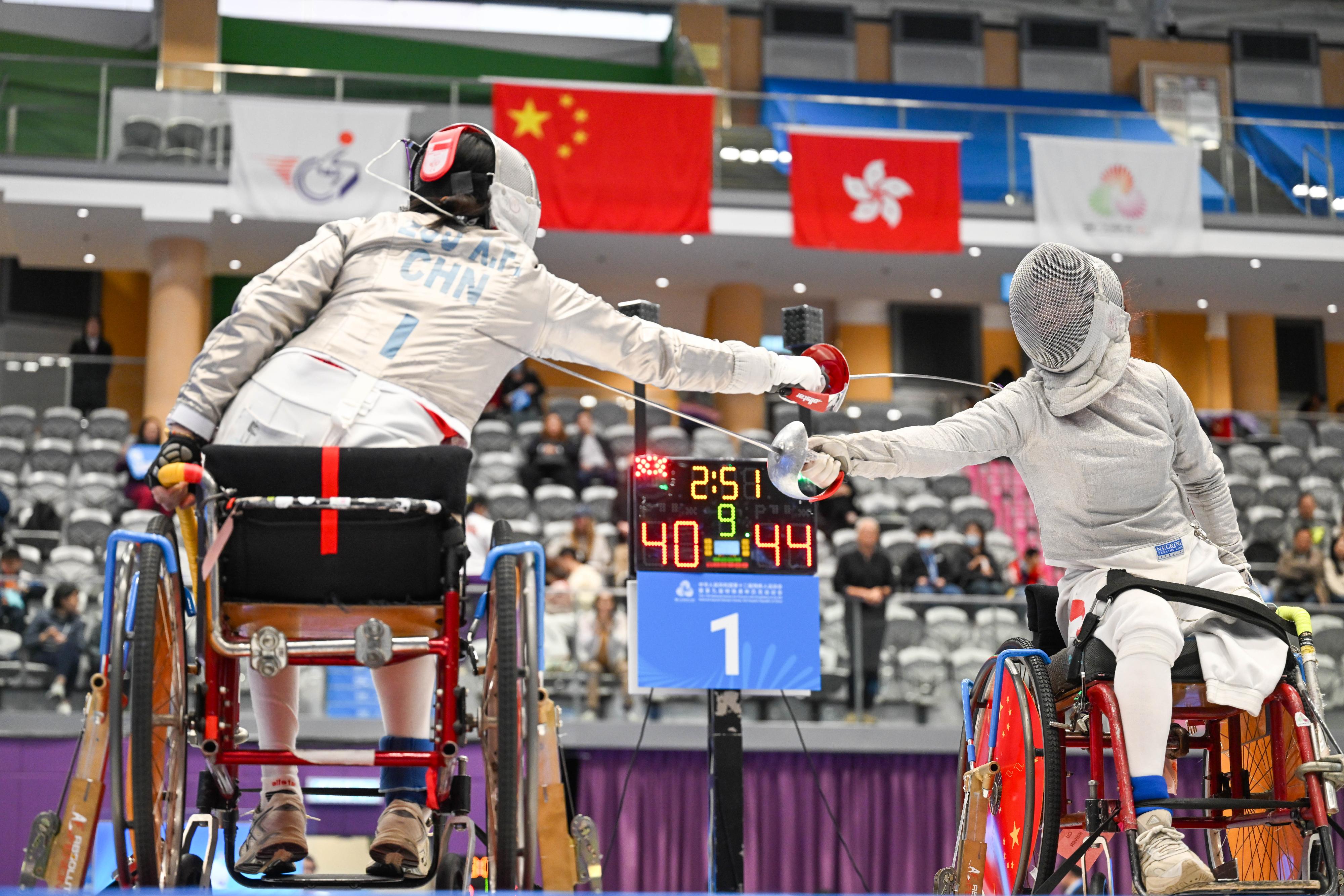 The women's sabre team of the Hong Kong Jockey Club Trophy wheelchair fencing competition of the 12th National Games for Persons with Disabilities and the 9th National Special Olympic Games was held at Ma On Shan Sports Centre today (December 14). Photo shows athletes competing in the event.