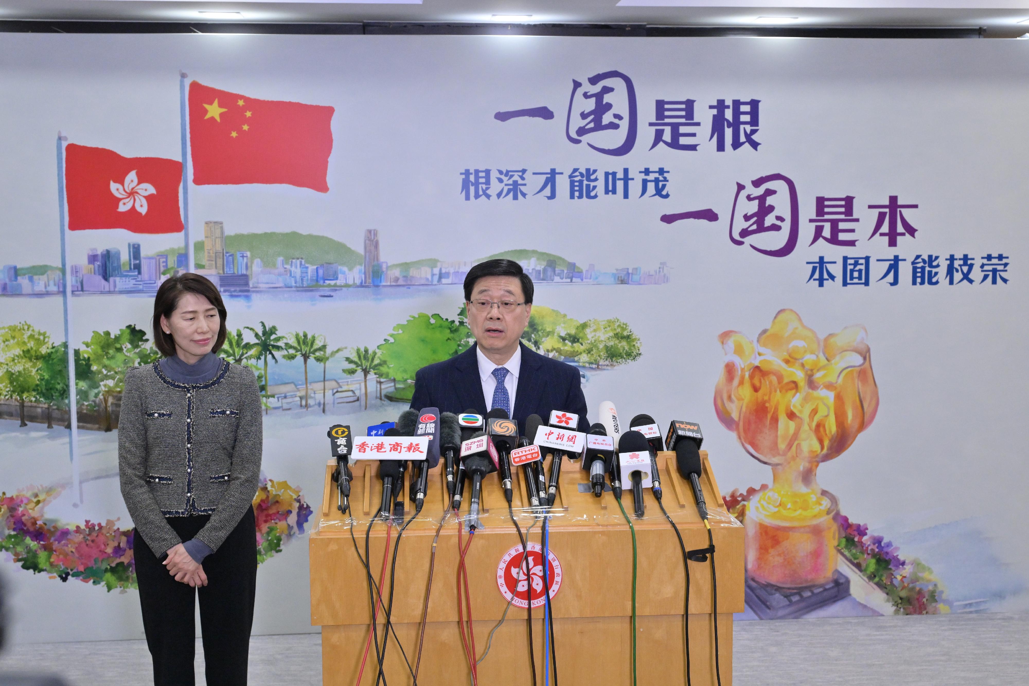 The Chief Executive, Mr John Lee (right), meets the media in Beijing after reporting to President Xi Jinping on work today (December 16). Looking on is the Director of the Chief Executive's Office, Ms Carol Yip (left).