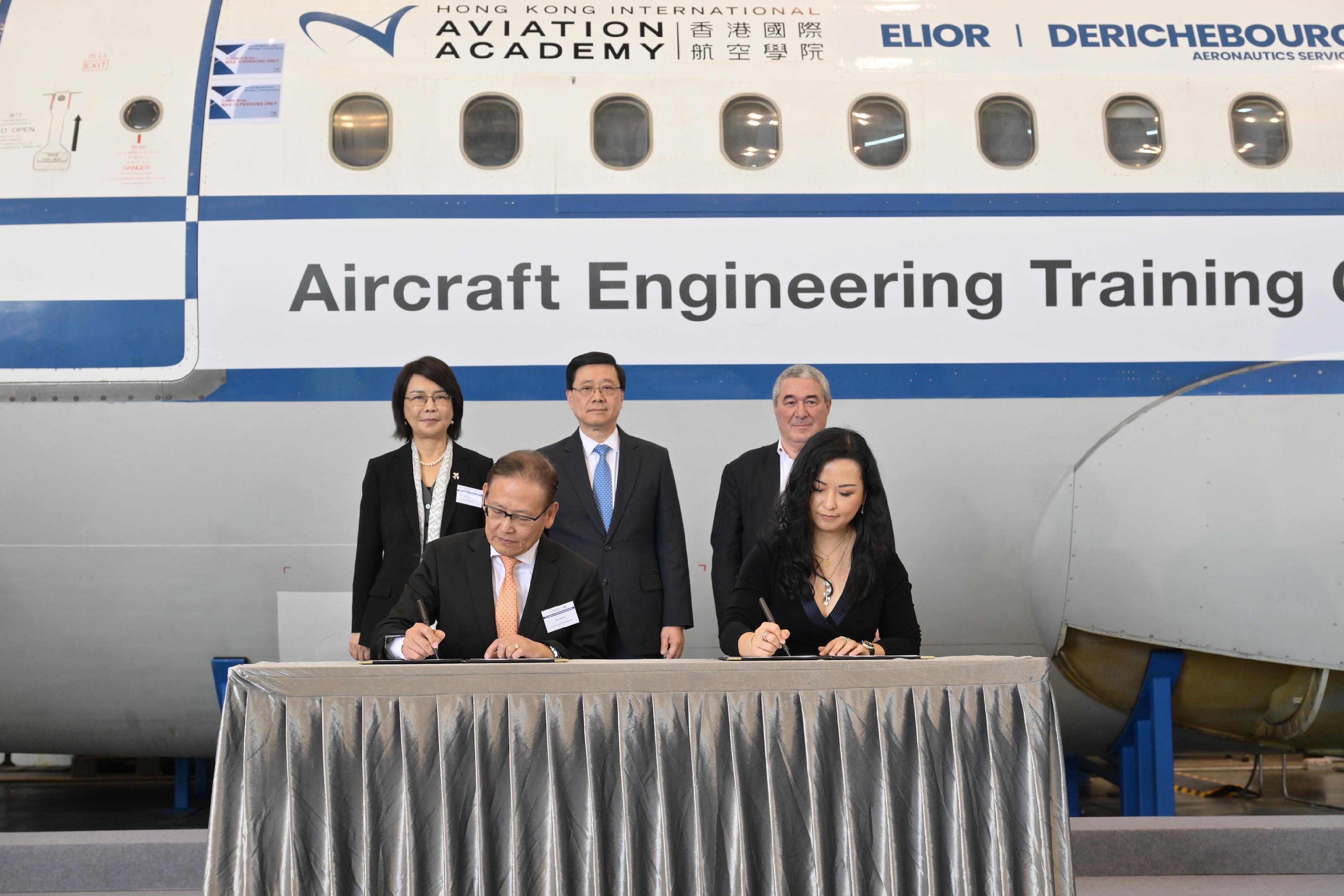 The Chief Executive, Mr John Lee, attended the Launch Ceremony of Aircraft Engineering Training Centre today (December 18). Photo shows (back row, from left) the Chief Executive Officer of the Airport Authority Hong Kong, Mrs Vivian Cheung; Mr Lee; the Group Chairman and Chief Executive Officer of Elior Group SA, Mr Daniel Derichebourg, witnessing the signing of agreement between (front row, from left) the President of the Hong Kong International Aviation Academy, Mr Simon Li, and the Chief Executive Officer of Elior Asia, Ms Janet Cheung.
