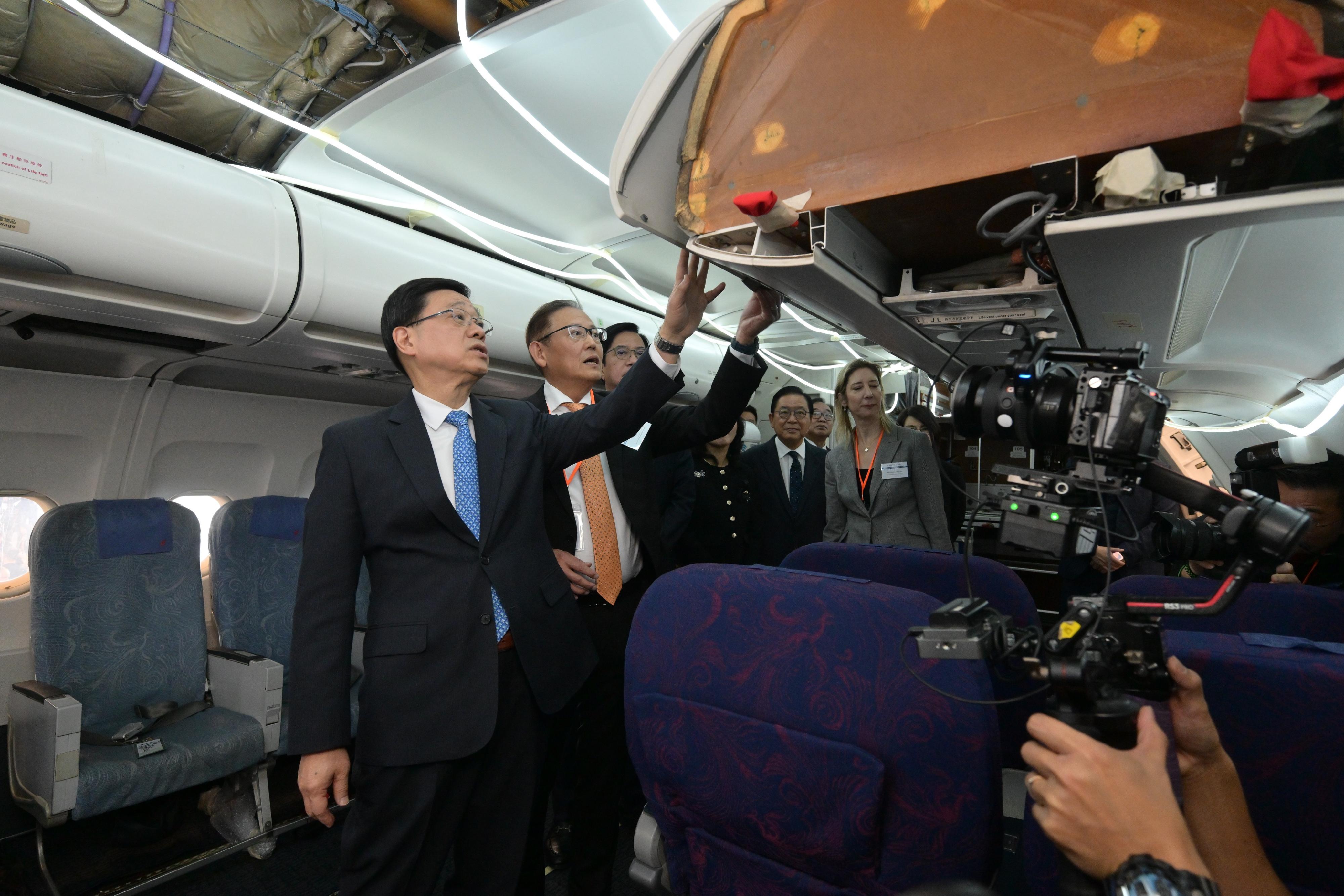 The Chief Executive, Mr John Lee, attended the Launch Ceremony of Aircraft Engineering Training Centre today (December 18). Photo shows Mr Lee (first left) touring the Aircraft Engineering Training Cabin.