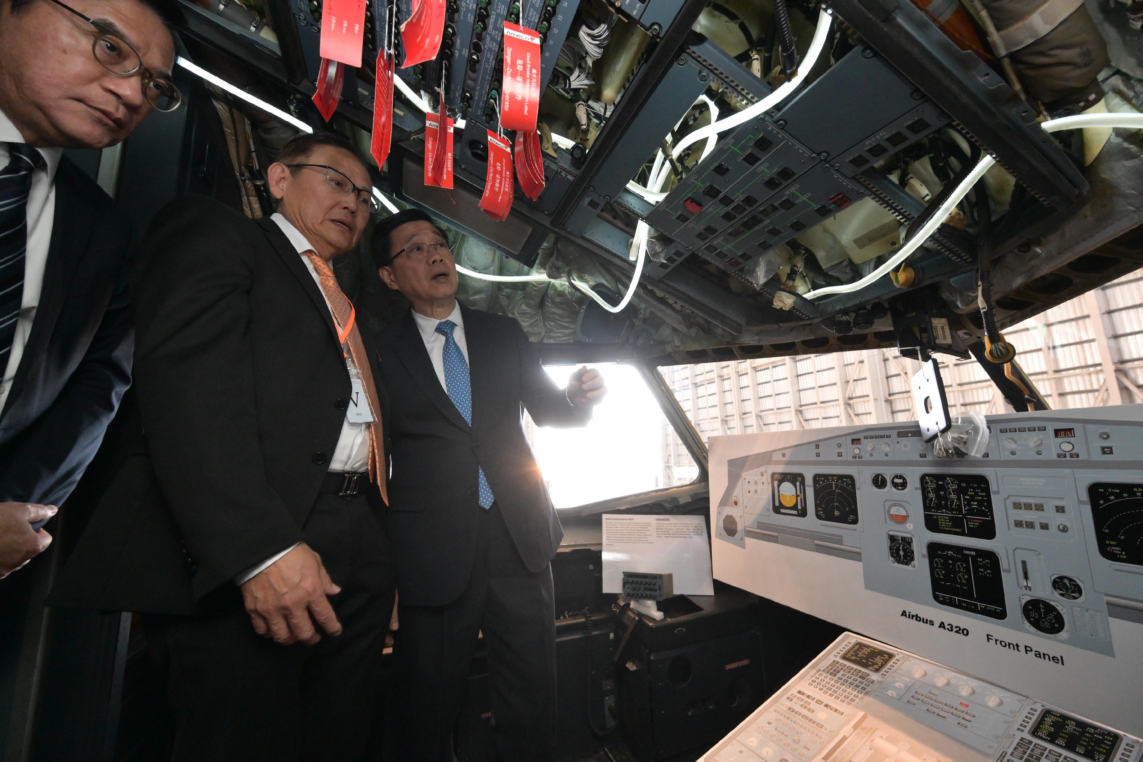 The Chief Executive, Mr John Lee, attended the Launch Ceremony of Aircraft Engineering Training Centre today (December 18). Photo shows Mr Lee (first right) touring the Aircraft Engineering Training Cabin.