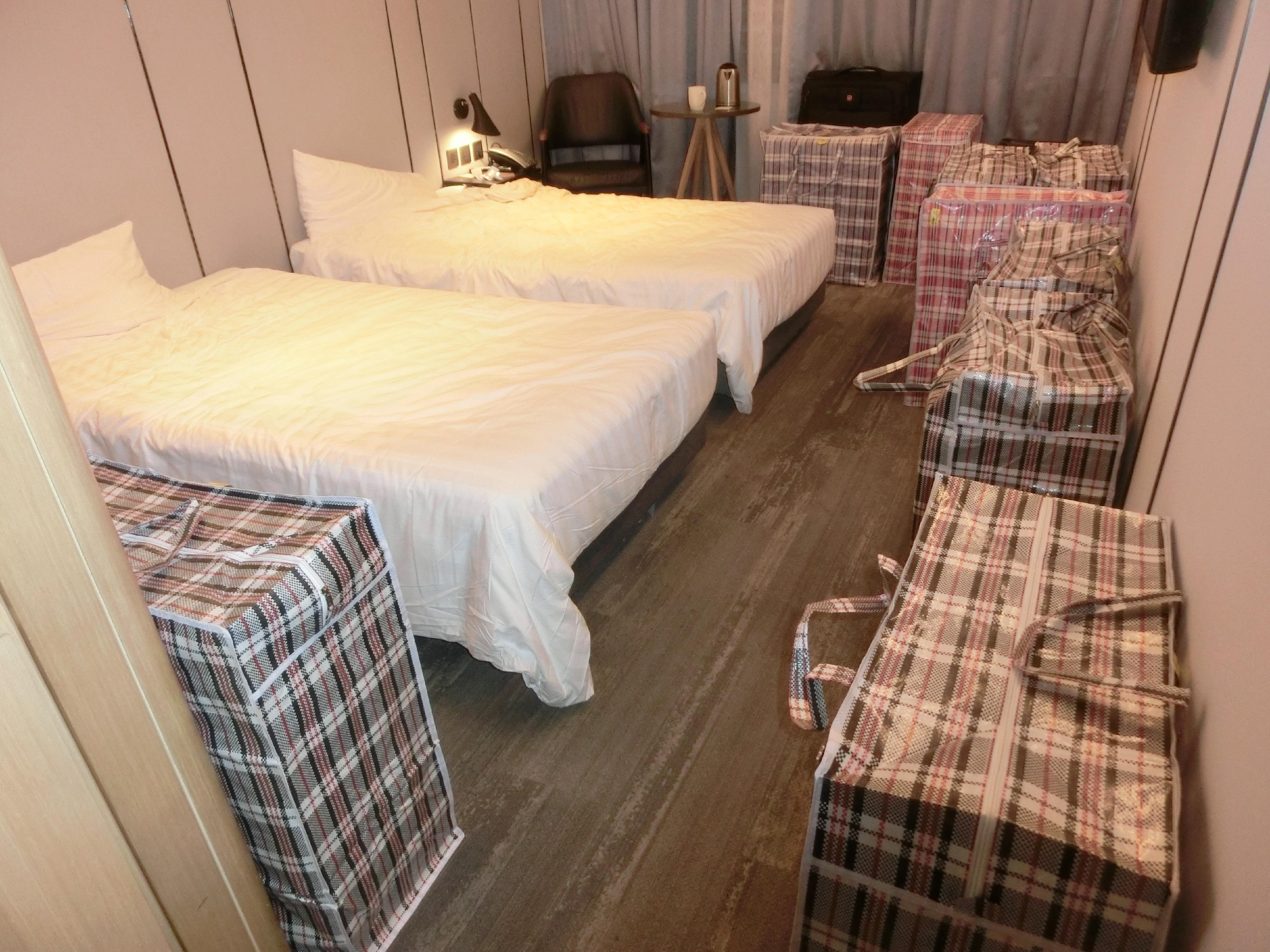 Hong Kong Customs mounted enforcement operations to combat illicit cigarette smuggling activities involving air passengers and shut down related illicit cigarette storage centres between September and December, successfully neutralising a transnational syndicate that smuggled illicit cigarettes through air passengers. Photo shows some of the illicit cigarettes seized in a hotel room.