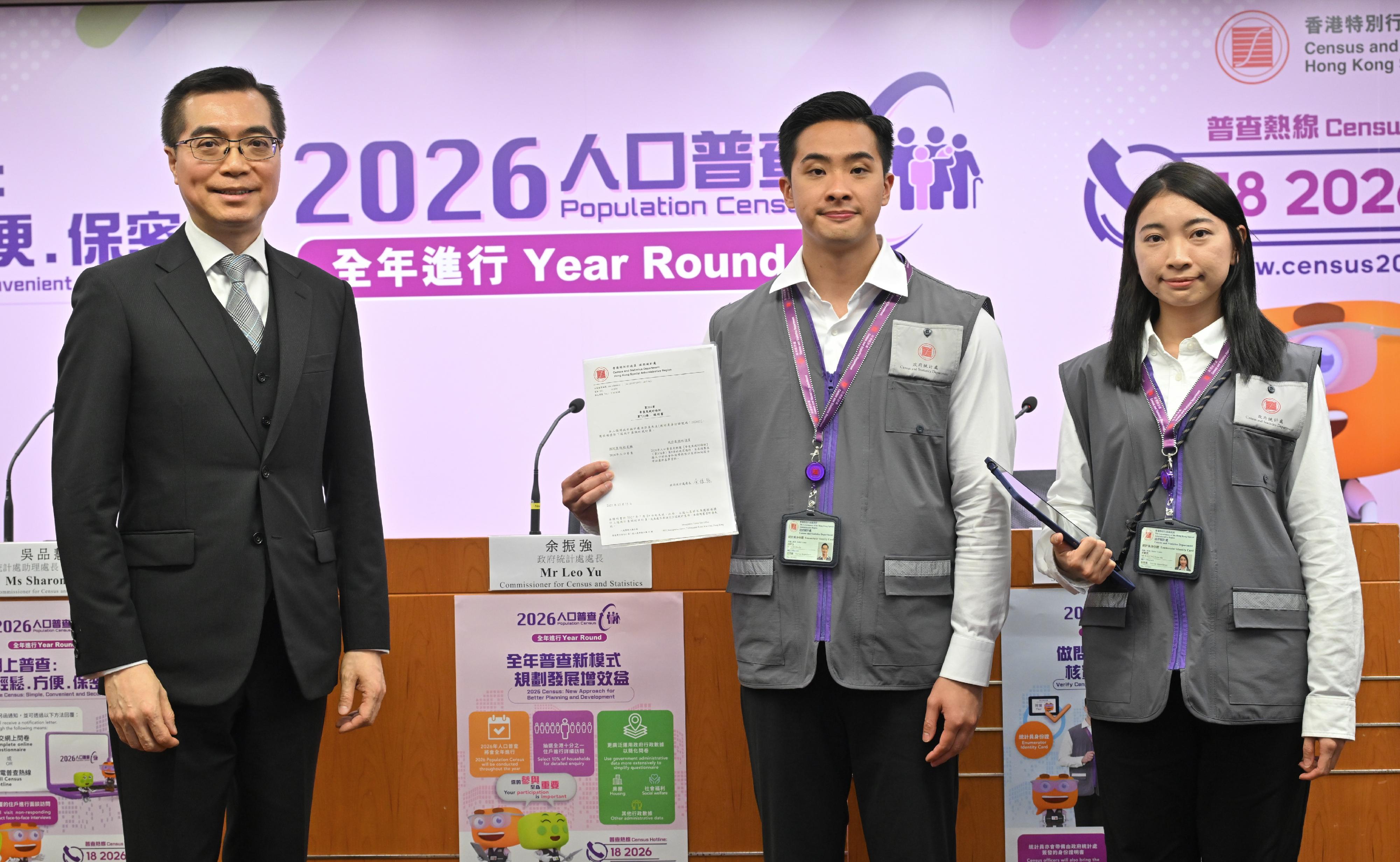 Announcing details of the 2026 Population Census at a press conference today (December 19), the Commissioner for Census and Statistics, Mr Leo Yu (first left), introduces the outfit of census officers, who may visit households with outstanding responses, including wearing a grey vest uniform and carrying an Enumerator Identity Card and a Census Officer Certificate of Identity issued by the Census and Statistics Department for identification purposes.  