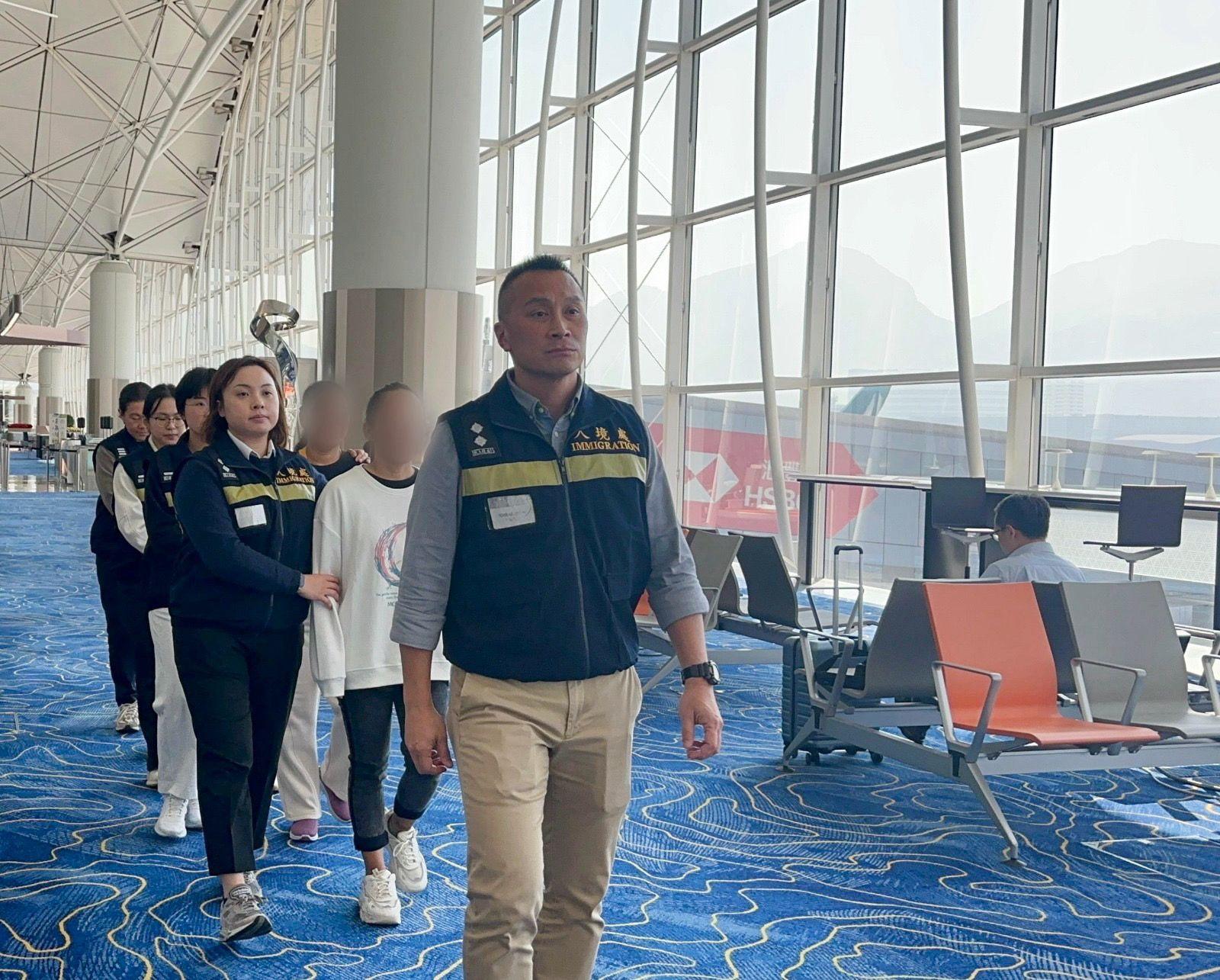 The Immigration Department (ImmD) carried out repatriation operations codenamed "Shield" for five consecutive days from December 15 to today (December 19). A total of 77 unsubstantiated non-refoulement claimants were repatriated to their places of origin. Photo shows removees being escorted by ImmD officers to depart from Hong Kong.