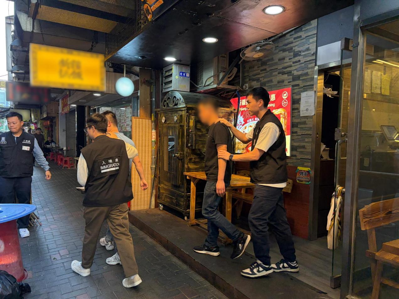 The Immigration Department mounted a series of territory-wide anti-illegal worker operations codenamed "Silver Wing" and "Twilight", joint operations with the Labour Department codenamed "Lightshadow" and "Rainbow", a joint operation with the Food and Environmental Hygiene Department and the Leisure and Cultural Services Department codenamed "Flabbergast" and a joint operation with the Hong Kong Police Force codenamed "Champion" from December 14 to yesterday (December 18). Photo shows suspected illegal workers arrested during an operation.