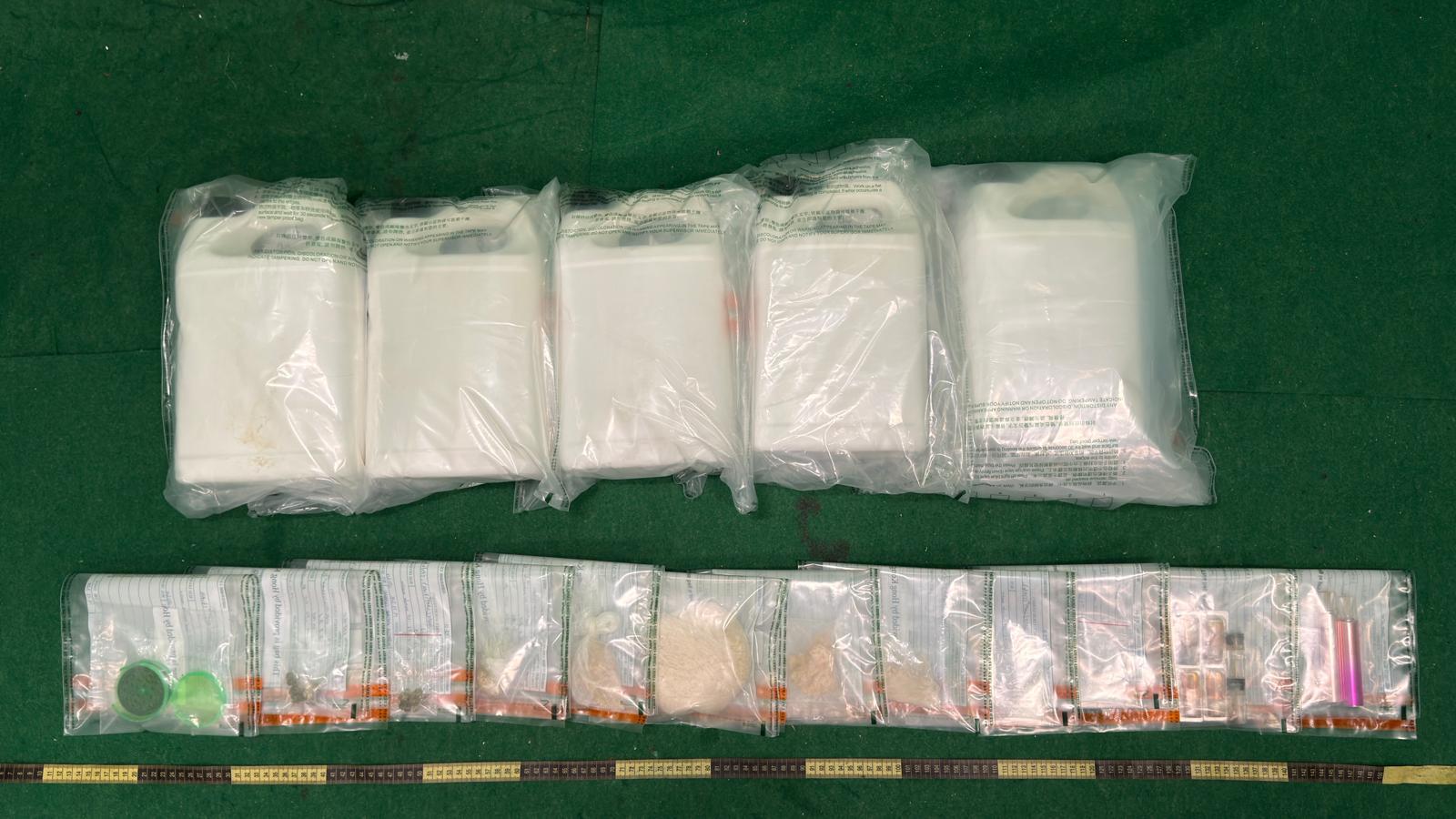 Hong Kong Customs on December 12 and yesterday (December 18) seized a total of about 20 kilograms of suspected liquid methamphetamine, 10 suspected cannabis oil vape capsules, about 4 grams of suspected cannabis buds, about 3 grams of suspected cocaine and about 270 grams of suspected cracked cocaine with an estimated market value of over $10.9 million at Hong Kong International Airport and in Tsim Sha Tsui. Photo shows the suspected liquid methamphetamine inside the bottle of protective liquid for natural stones and the suspected dangerous drugs found in the premises of the arrested person.

