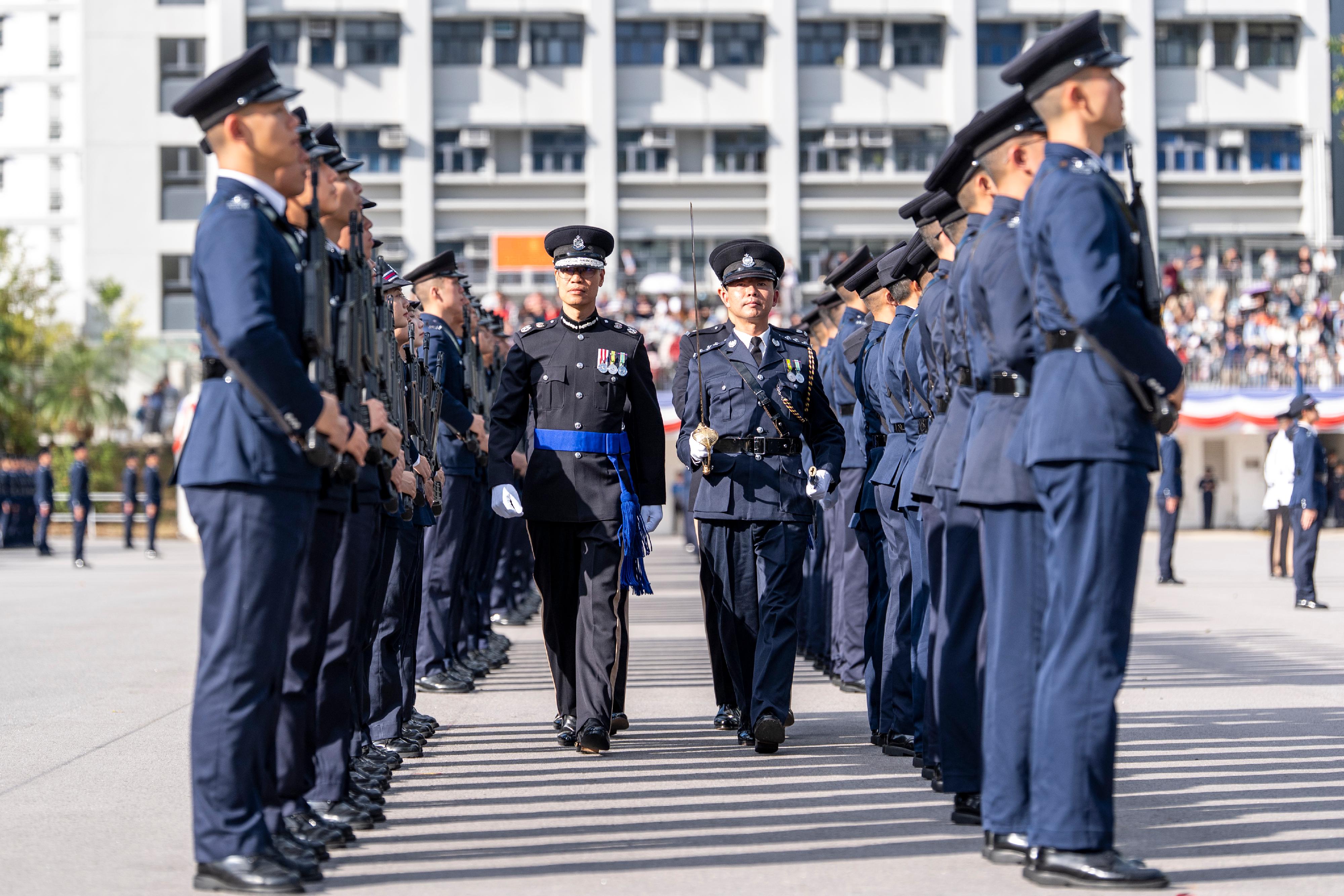 The Deputy Commissioner of Police (Operations), Mr Yip Wan-lung, inspects a passing-out parade as reviewing officer at the Hong Kong Police College today (December 20).