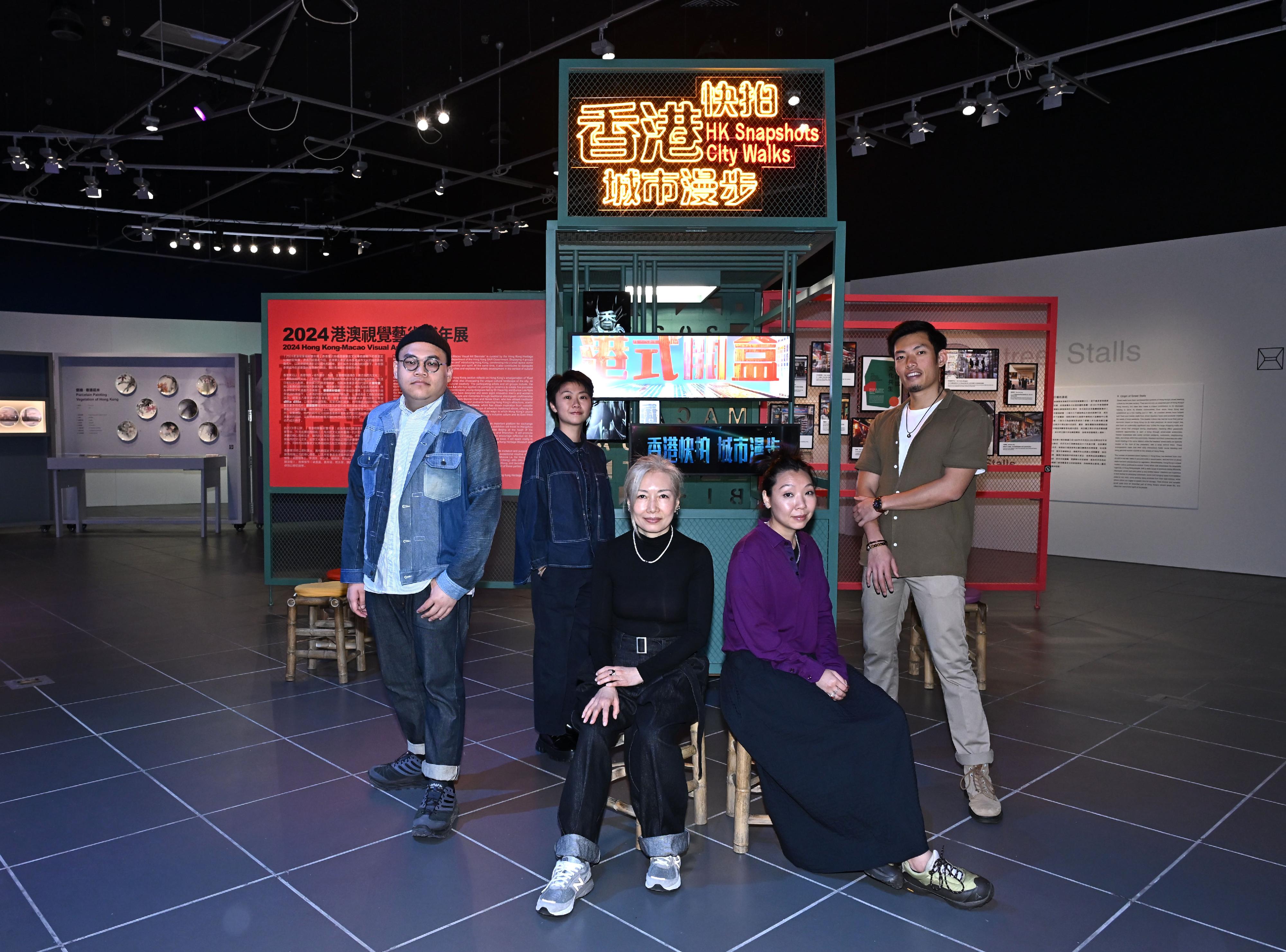 The Hong Kong Heritage Museum presents the "HK Snapshots‧City Walks: Fresh Takes on Hong Kong's Art and Cultural Heritage" exhibition until March 2 next year, featuring artworks created by four groups of young local artists. Photo shows AI-generated video creator Raymond Hung, graphic designer Jacintha Chan, creative director Pauline Leung, project manager Lindt Cheung, and interview video director Gavin Wong from Key-Point Productions, and their artwork "HK Snapshots‧City Walks" exhibition installation.