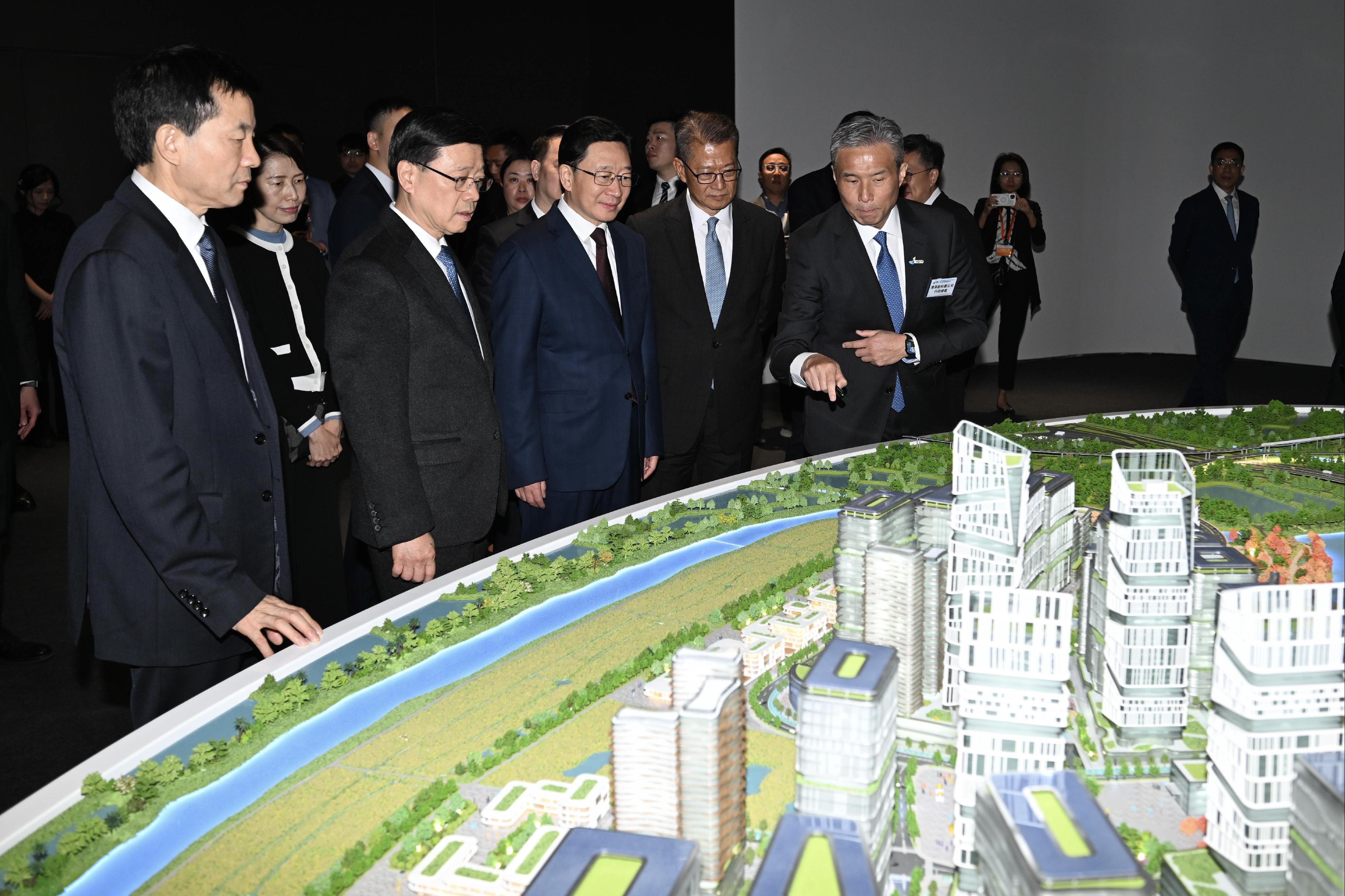 The Chief Executive, Mr John Lee, attended the Hong Kong-Shenzhen Innovation and Technology Park opening ceremony today (December 22). Photo shows (front row, from left) the Executive Deputy Director of the Hong Kong and Macao Affairs Office of the State Council, Mr Xu Qifang; Mr Lee; the Director of the Liaison Office of the Central People's Government in the Hong Kong Special Administrative Region, Mr Zhou Ji; and the Financial Secretary, Mr Paul Chan, listening to a briefing by the Chief Executive Officer of the Hong Kong-Shenzhen Innovation and Technology Park Limited, Mr Vincent Ma (front row, first right), on Hetao Hong Kong Park and Shenzhen Park.