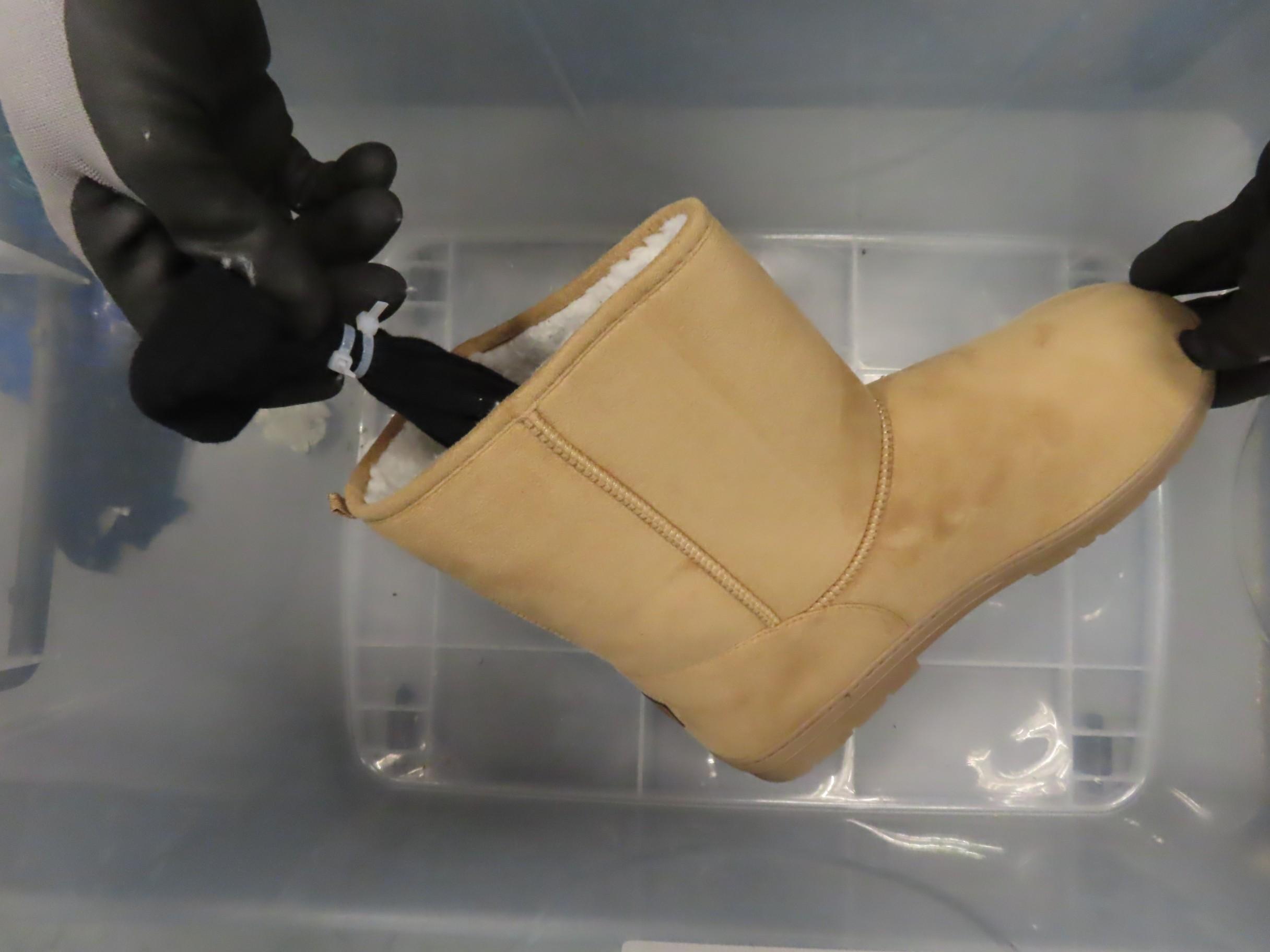 Hong Kong Customs seized 13 suspected scheduled endangered live lizards with an estimated market value of about $92,000 at Hong Kong International Airport on December 27. Photo shows one of the seized suspected scheduled endangered live lizards which was wrapped in a sock and concealed inside a boot. 
