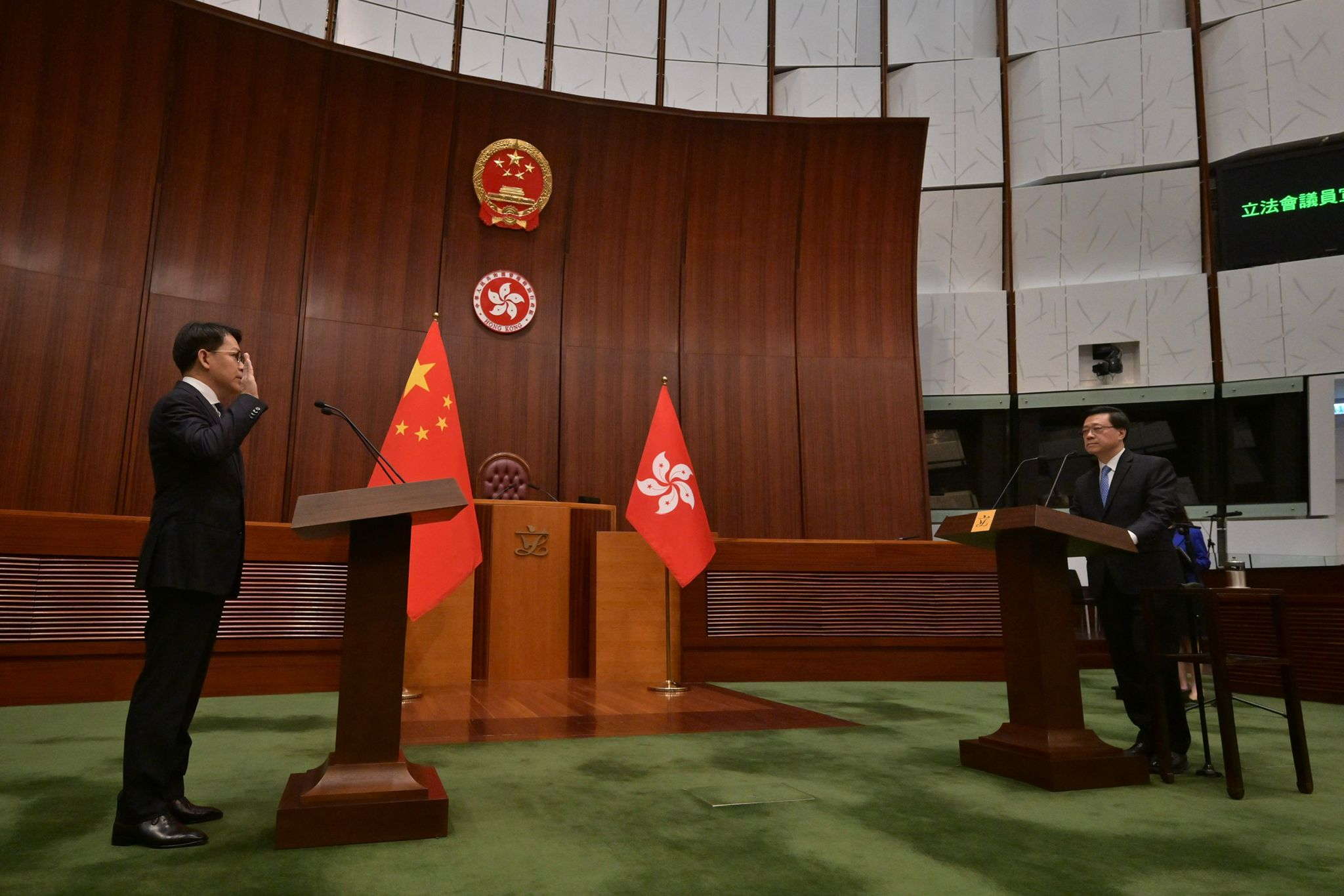 The Chief Executive, Mr John Lee (right), administers the oath-taking of members of the eighth-term Legislative Council (LegCo) at the Chamber of the LegCo Complex today (January 1).