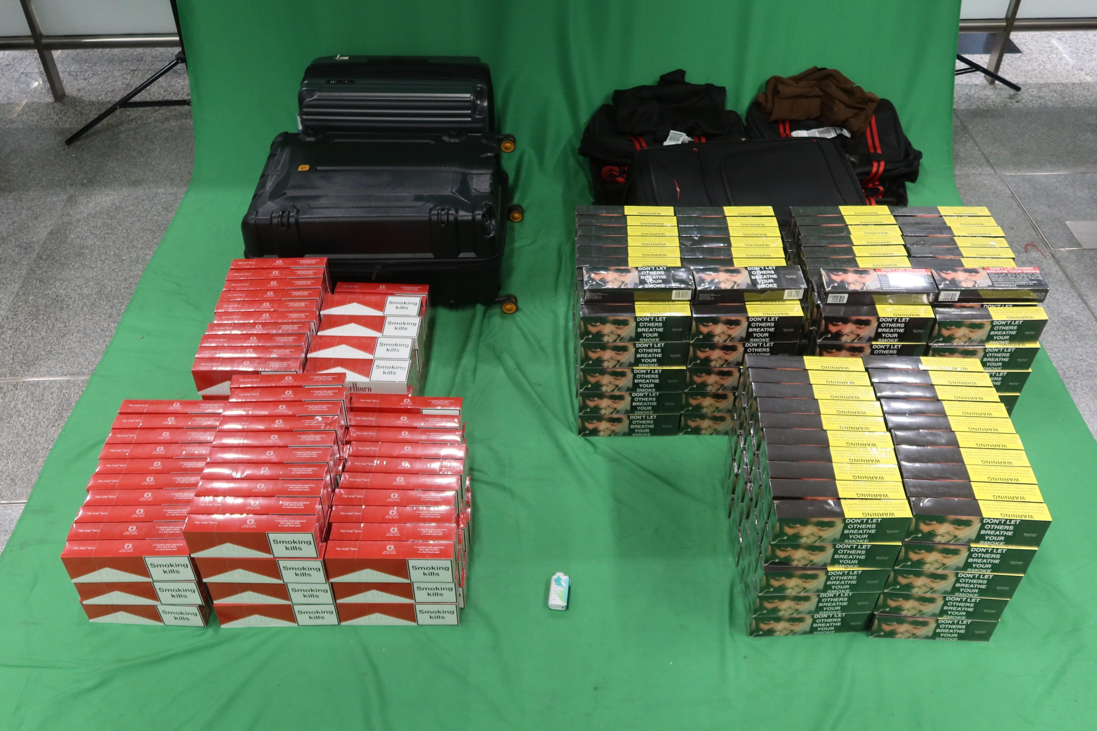 A 22-year-old incoming female passenger was sentenced to six months' imprisonment and fined $2,000 by the West Kowloon Magistrates' Courts today (January 5) for importing duty-not-paid cigarettes and failing to declare them to Customs Officers, as well as for importing an alternative smoking product, in contravention of the Dutiable Commodities Ordinance and the Import and Export Ordinance. Photo shows the duty-not-paid cigarettes and the alternative smoking product seized.