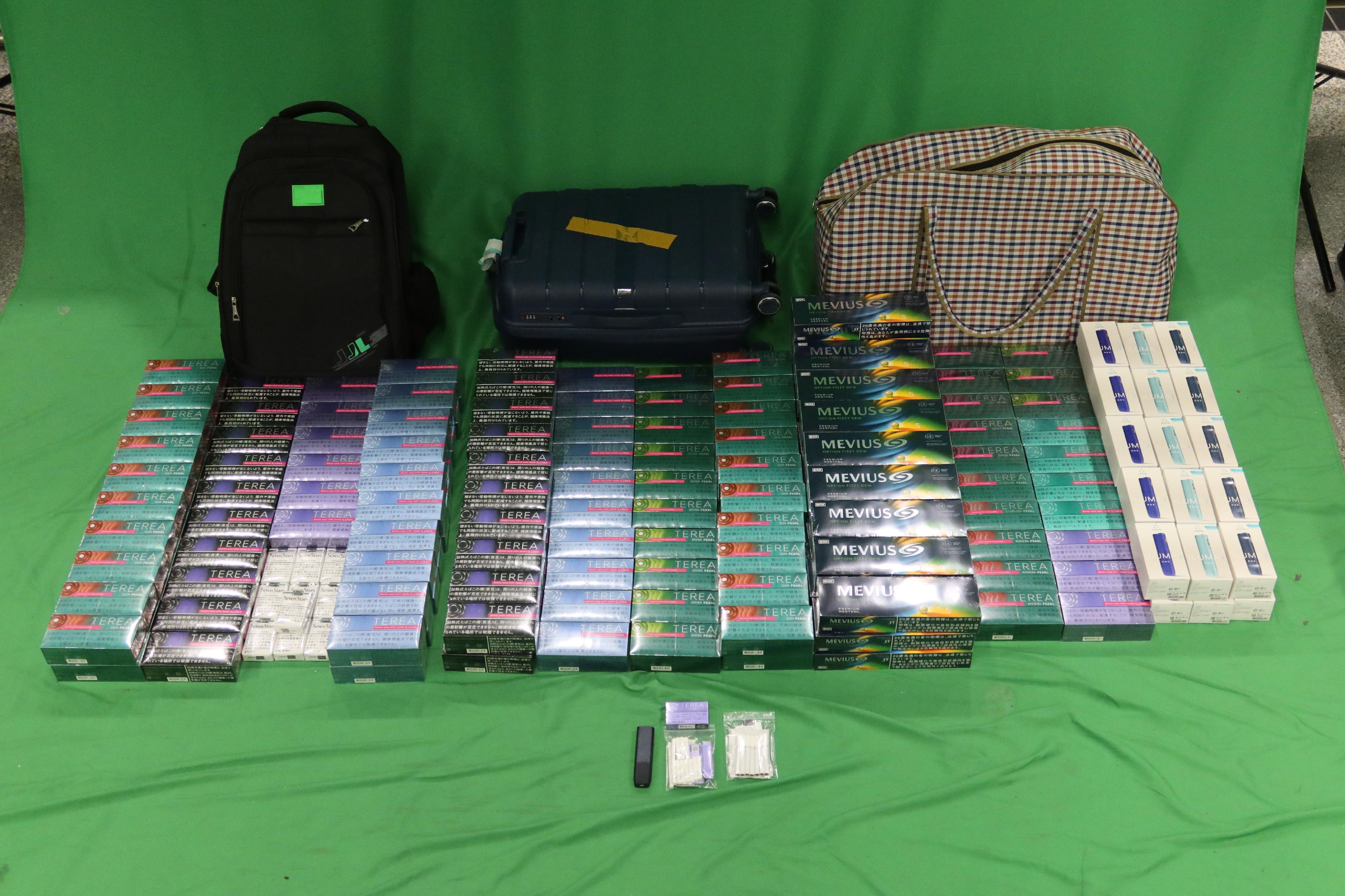 One incoming 31-year-old male passenger was sentenced to three months imprisonment by the West Kowloon Magistrates' Courts today (January 7) for importing duty-not-paid cigarettes and failing to declare them to Customs officers, as well as for importing alternative smoking products, in contravention of the Dutiable Commodities Ordinance and the Import and Export Ordinance. Photo shows the duty-not-paid cigarettes, alternative smoking products and alternative smoking product devices seized. 