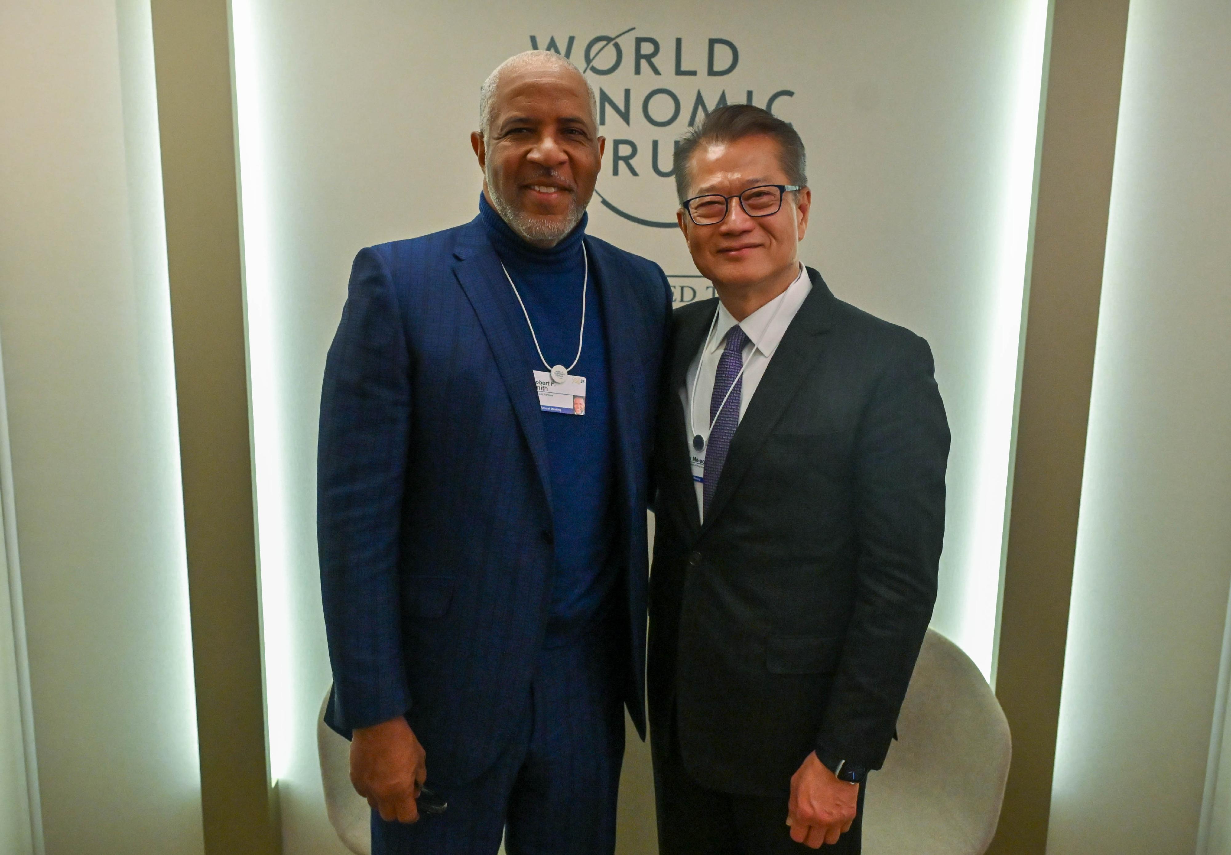 The Financial Secretary, Mr Paul Chan, continued his programme at the World Economic Forum Annual Meeting in Davos, Switzerland, yesterday (January 20, Davos time). Photo shows Mr Chan (right) meeting with the Founder, Chairman and Chief Executive Officer of a technology investment firm, Vista Equity Partners, Mr Robert Smith (left), in Davos, Switzerland.

