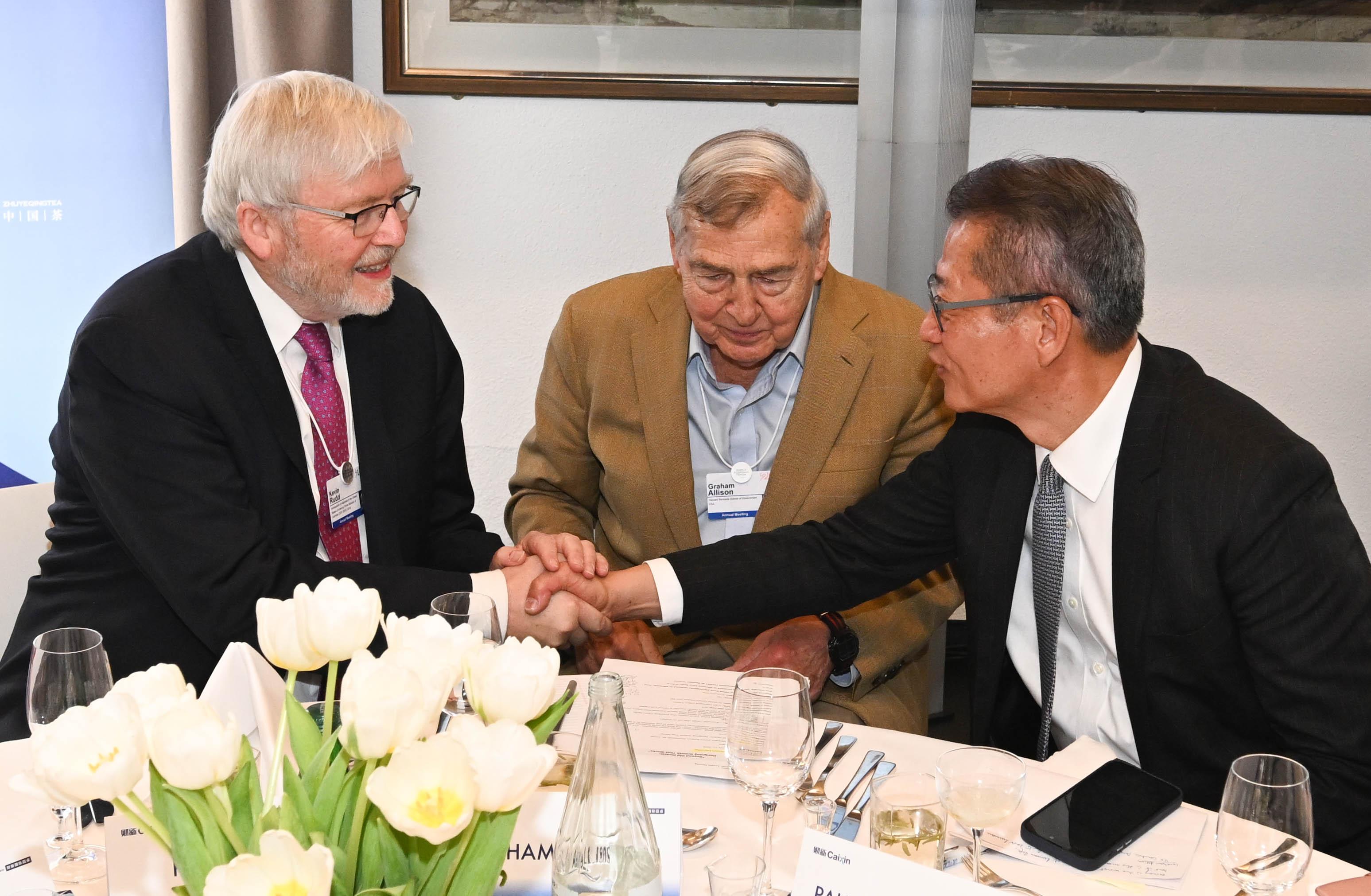 The Financial Secretary, Mr Paul Chan, continued his activities at the World Economic Forum Annual Meeting in Davos, Switzerland, and met with government officials and business leaders from various places yesterday (January 21, Davos time). Photo shows Mr Chan (right) chatting with Australia's Ambassador to the United States, Dr Kevin Rudd (left), at the 2026 Davos-Caixin CEO Luncheon.