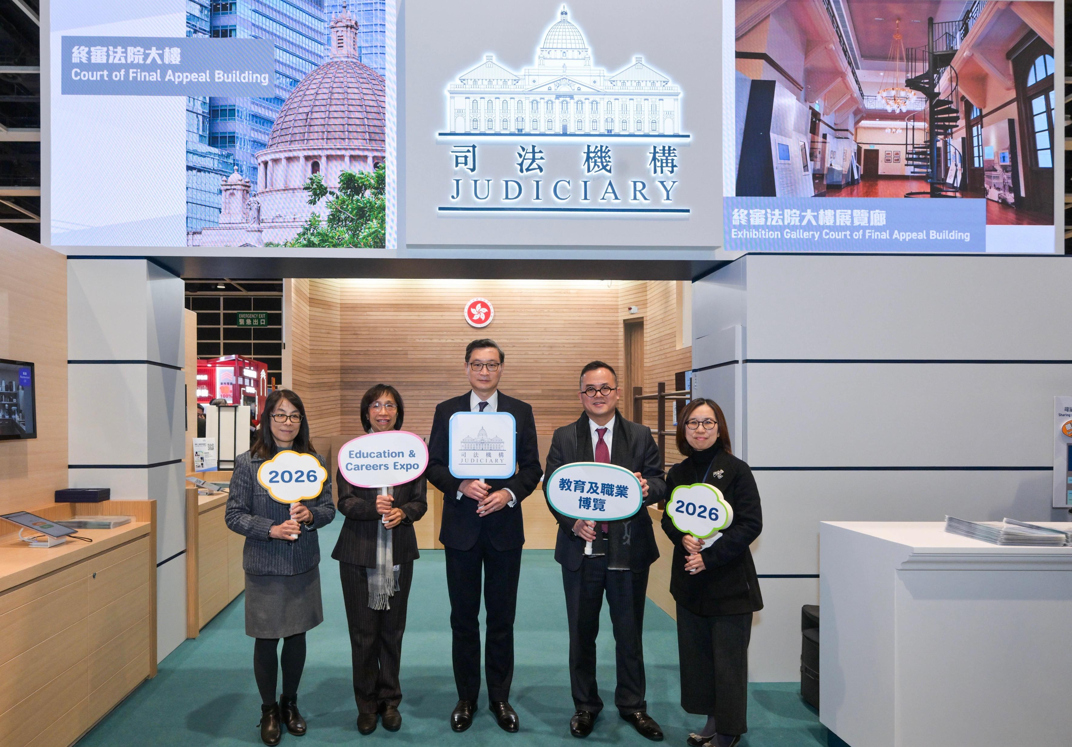 Mr Justice Jeremy Poon, Chief Judge of the High Court (centre), and the Judiciary Administrator, Ms Esther Leung (second left), unveil the Judiciary's booth at the Education & Careers Expo 2026 today (January 22).