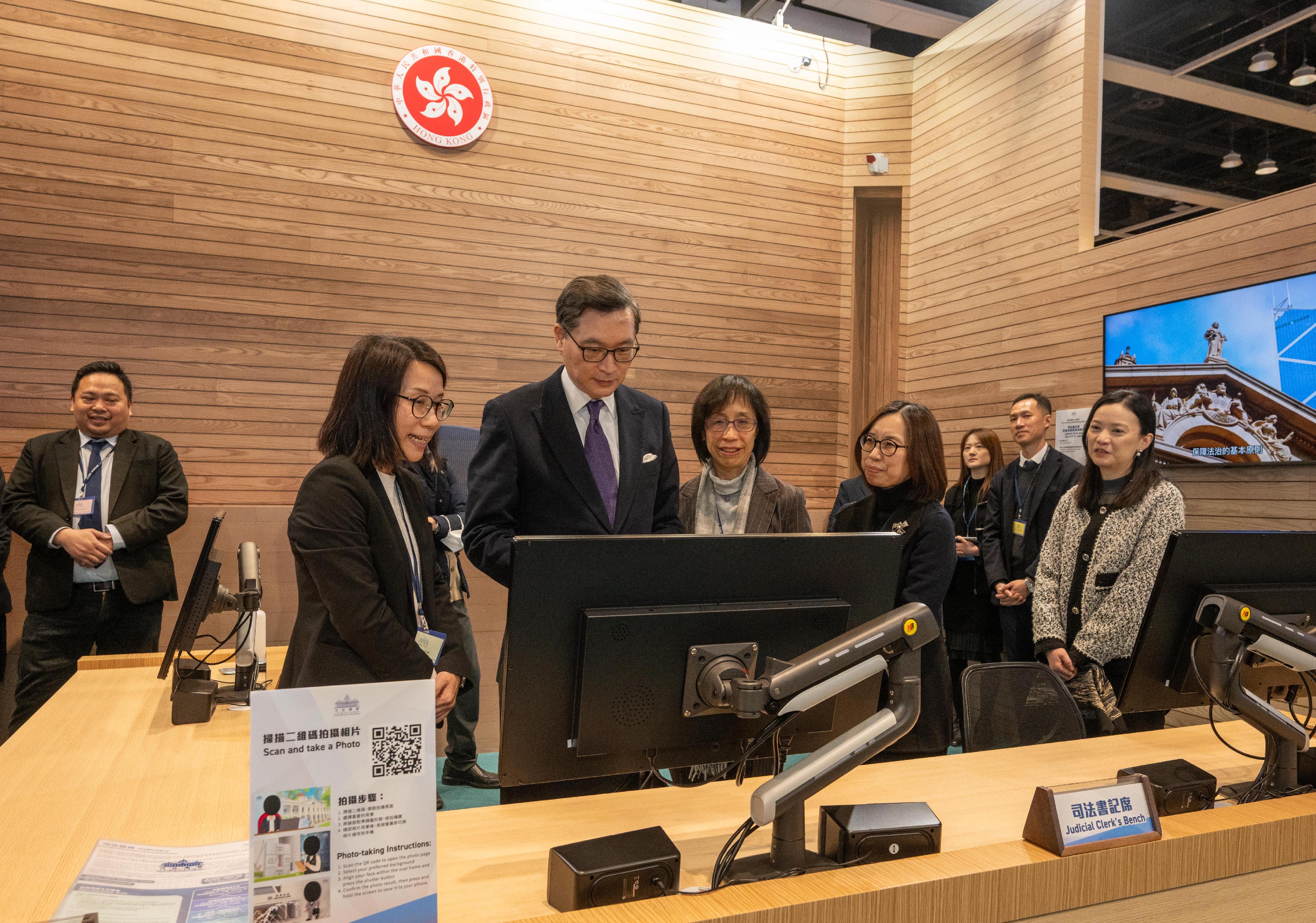 Mr Justice Jeremy Poon, Chief Judge of the High Court (third left), and the Judiciary Administrator, Ms Esther Leung (fourth left), visit the Judiciary's booth at the Education & Careers Expo 2026 today (January 22).