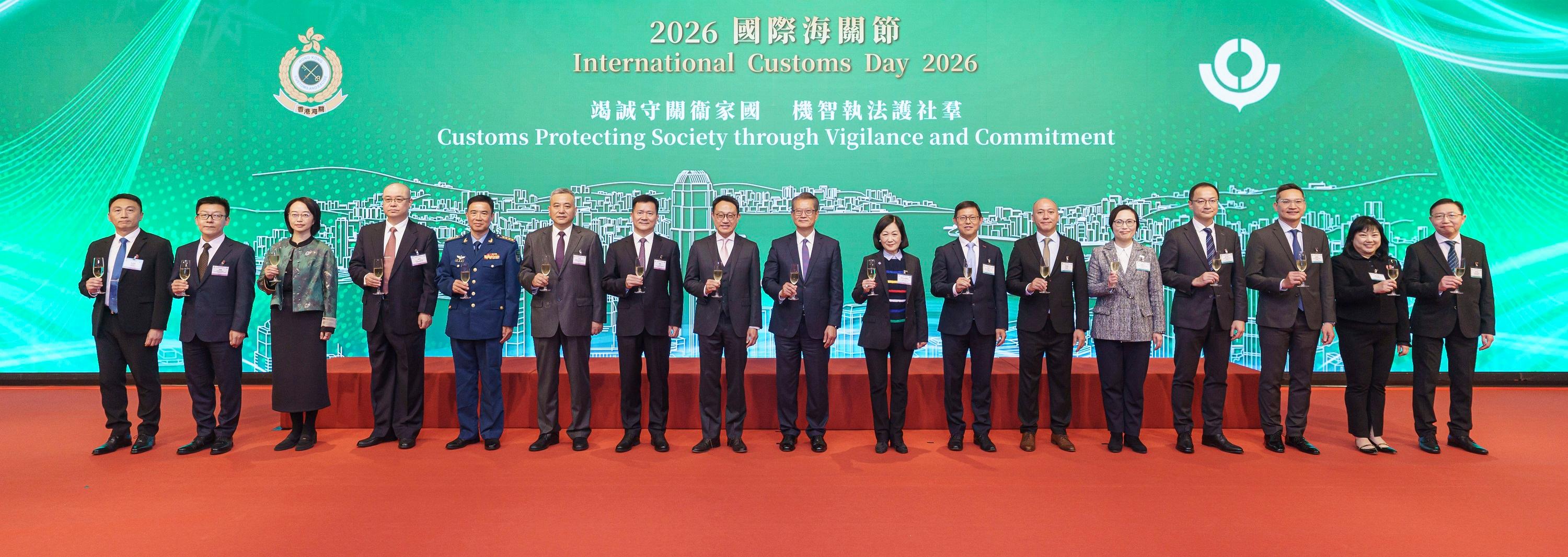 The Financial Secretary, Mr Paul Chan (center), and the Commissioner of Customs and Excise, Mr Chan Tsz-tat (eighth left), proposed a toast at a reception of International Customs Day 2026 today (January 27). Joining them are the Convenor of the Non-official Members of the Executive Council, Mrs Regina Ip (eighth right), the Deputy Head of the Office for Safeguarding National Security of the Central People's Government in the Hong Kong Special Administrative Region, Mr Chen Feng (seventh left), the Deputy Director-General of the Economic Affairs Department and Head of the Commercial Office of the Liaison Office of the Central People's Government in the Hong Kong Special Administrative Region, Mr Zhou Qiang (sixth left), the Deputy Chief of Staff of the Chinese People's Liberation Army Hong Kong Garrison, Senior Colonel Jiang Junde (fifth left), the Deputy Director General of the Guangdong Sub-Administration of the General Administration of Customs of the People's Republic of China, Mr Jiang Kui (fourth left); the Director-General of the Department of Treaty and Law of the Office of the Commissioner of the Ministry of Foreign Affairs of the People's Republic of China in the Hong Kong Special Administrative Region, Ms Zhou Qian (third left), the Deputy Director-General of the Police Liaison Department of the Liaison Office of the Central People's Government in the Hong Kong Special Administrative Region, Mr Sun Wei (second left); the Assistant Director-General of the Macao Customs Service, Mr Ip Wa-chio (first left) and the directorates of Hong Kong Customs. 