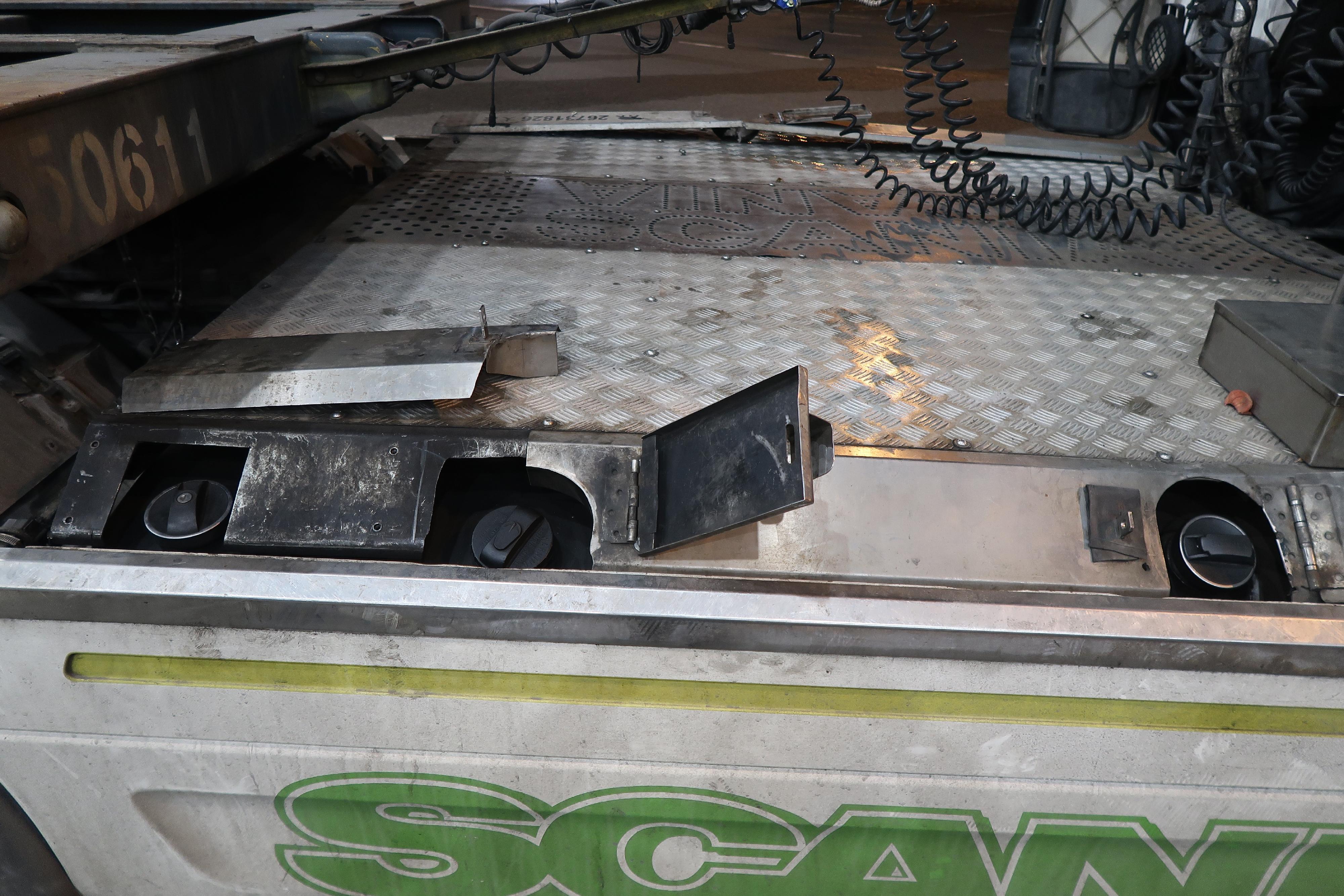 Hong Kong Customs on February 6 detected an illicit fuel smuggling case involving a cross-boundary lorry at the Shenzhen Bay Control Point and found a suspected altered structure inside the fuel tanks of the tractor of the lorry. Approximately 1 320 litres of unmanifested motor spirit were seized. Photo shows an extra fuel tank cap found under metal cover panels on the left and right sides of the tractor of the lorry, with suspected illicit motor spirit concealed inside.