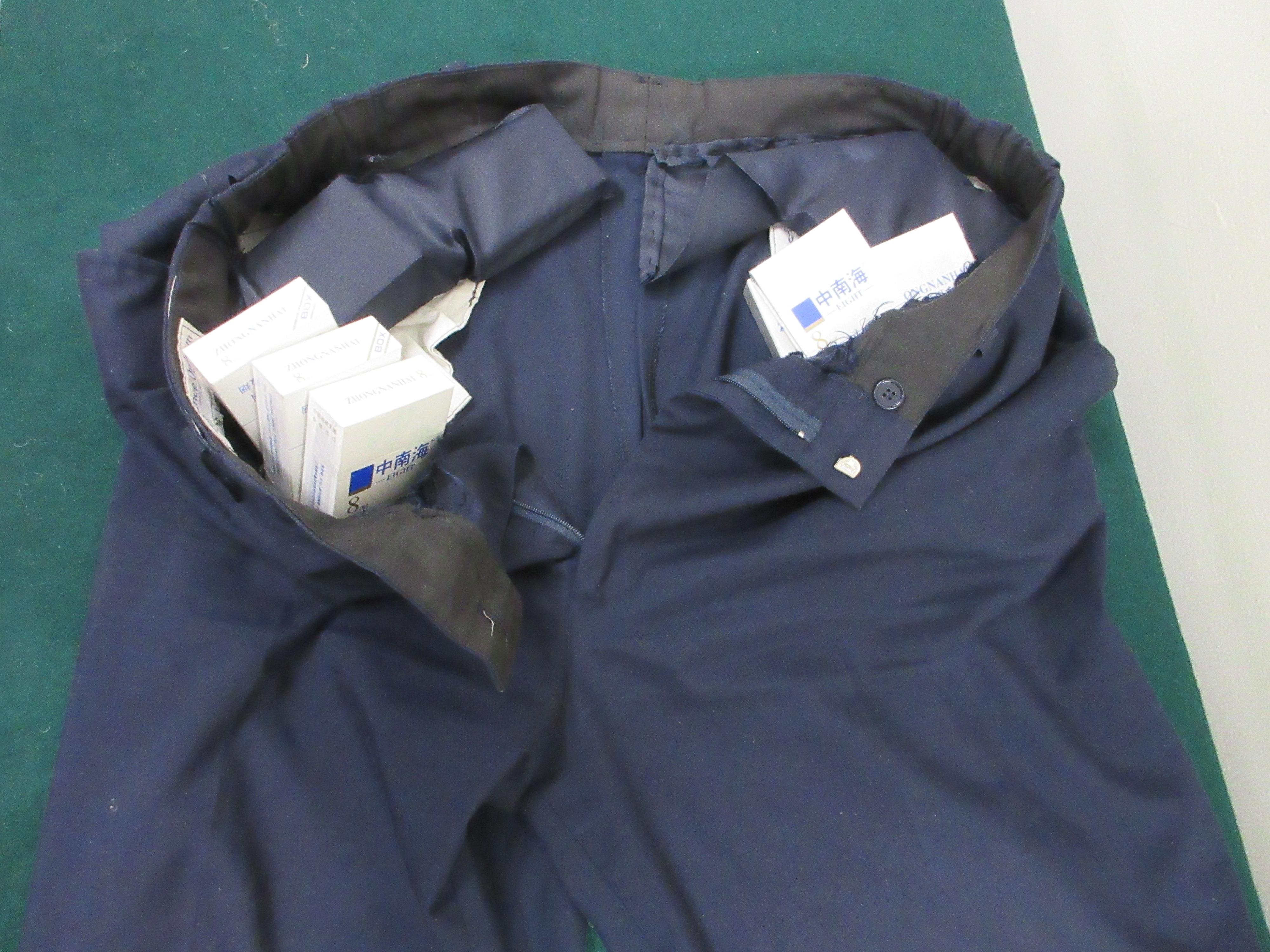 An incoming male passenger was sentenced to four weeks' imprisonment and fined $1,500 at the Fanling Magistrates' Courts yestderday (February 11) for possessing duty-not-paid cigarettes and failing to declare them to Customs officers, in contravention of the Dutiable Commodities Ordinance. Photo shows the duty-not-paid cigarettes seized from the pockets of the passenger's trousers.