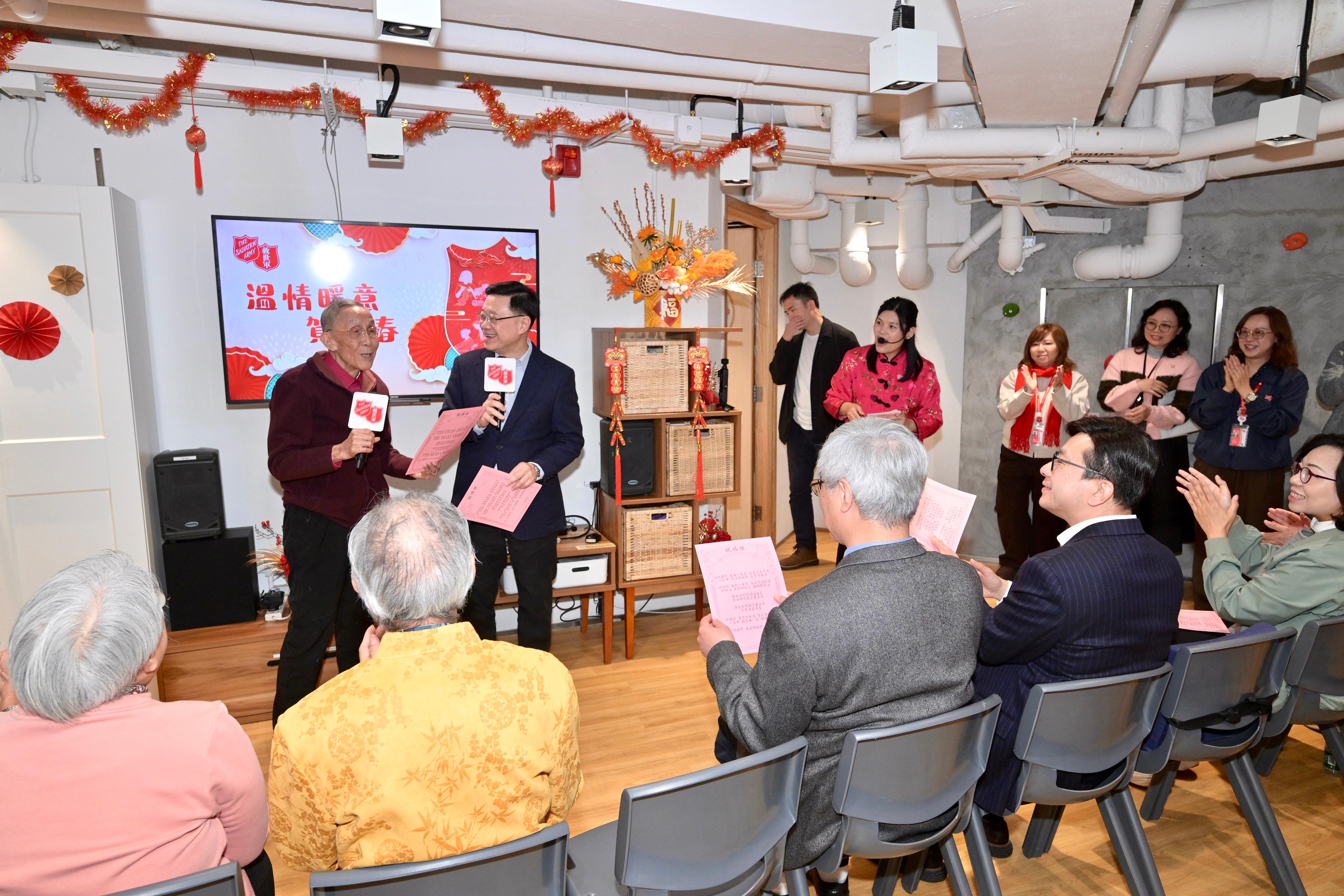 The Chief Executive, Mr John Lee, visited Yau Ma Tei today (February 13). Photo shows Mr Lee (second left) visiting Yaumatei Multi-service Centre for Senior Citizens of the Salvation Army and interacting with residents of the district.
