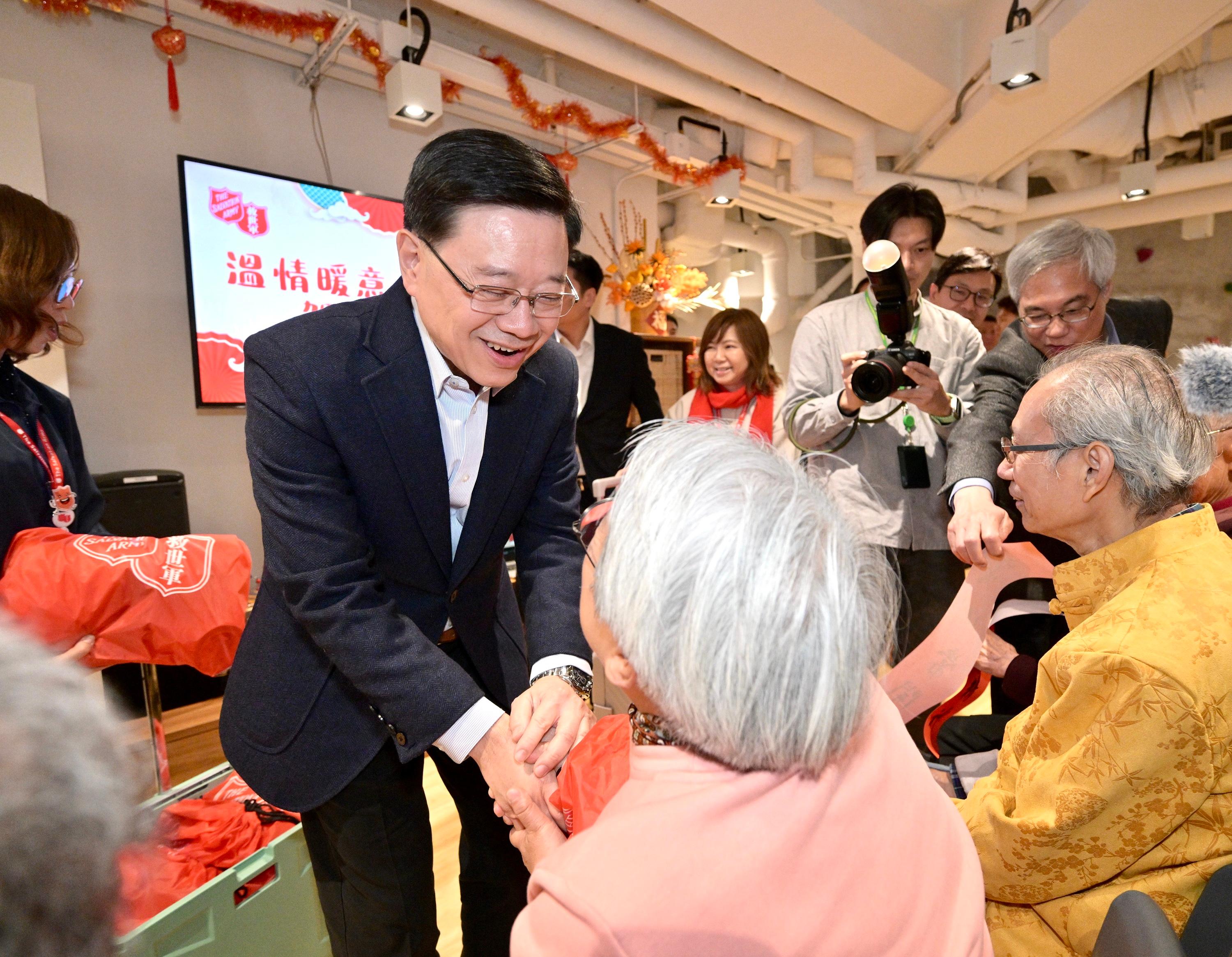 The Chief Executive, Mr John Lee, visited Yau Ma Tei today (February 13). Photo shows Mr Lee (first left) visiting Yaumatei Multi-service Centre for Senior Citizens of the Salvation Army and interacting with residents of the district.