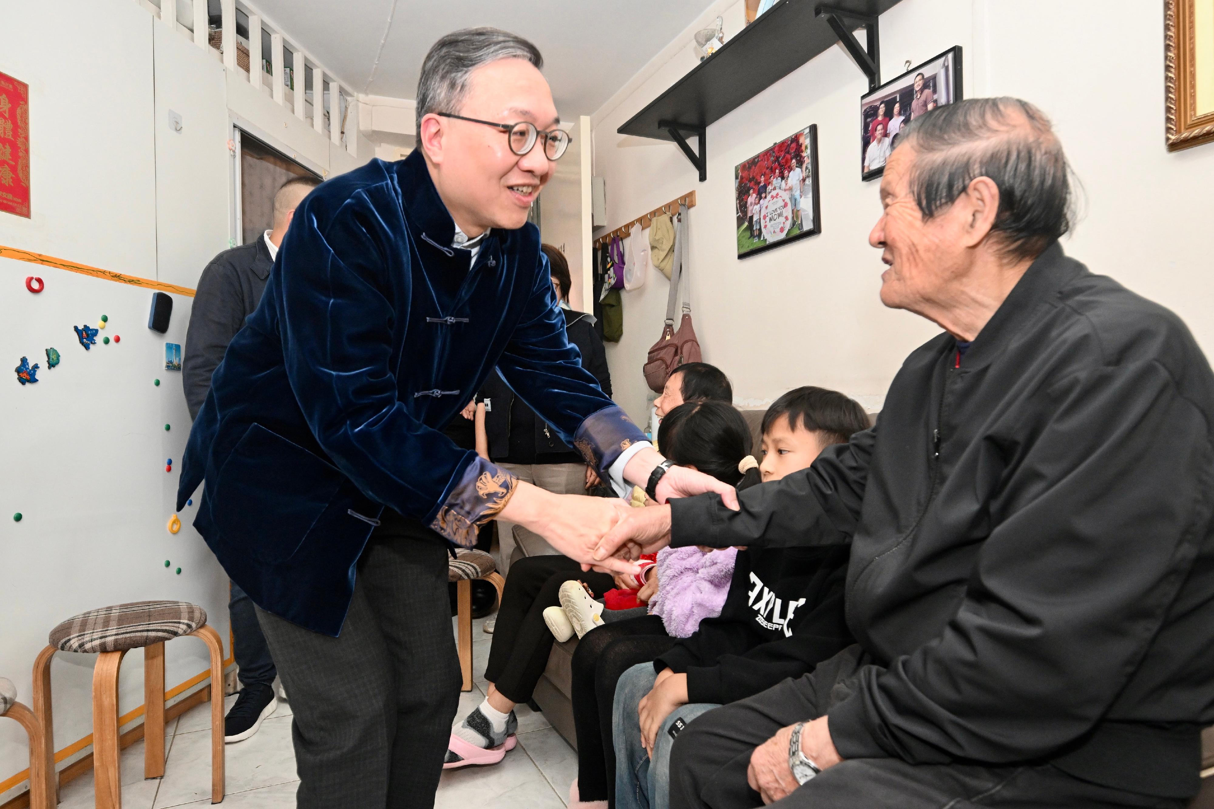 The Secretary for Justice, Mr Paul Lam, SC (left), visits an elderly doubletons living in Lai Tak Tsuen to engage them in warm conversations and send them greetings.