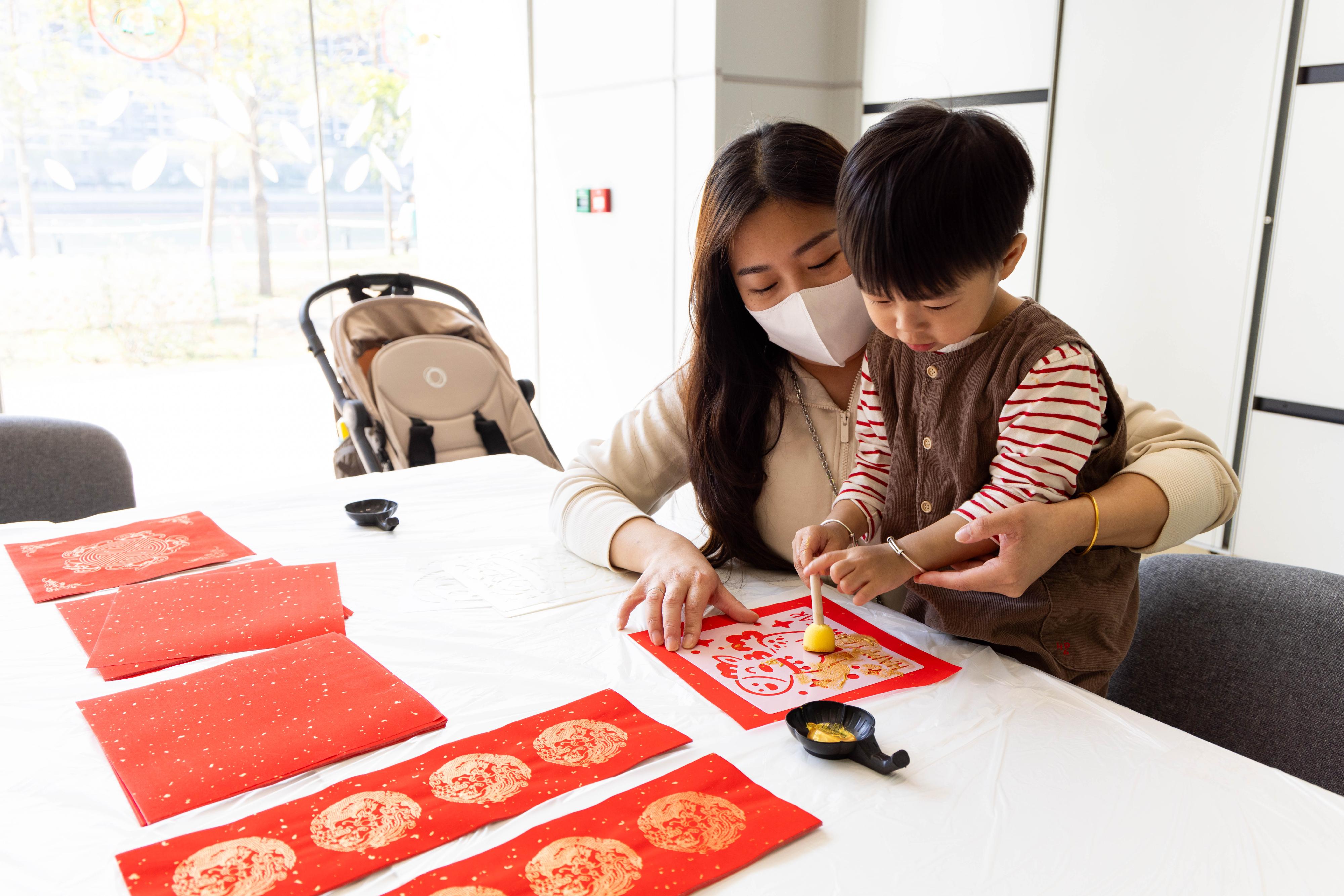 A patient joyfully designs Lunar New Year decorations at Hong Kong Children's Hospital.