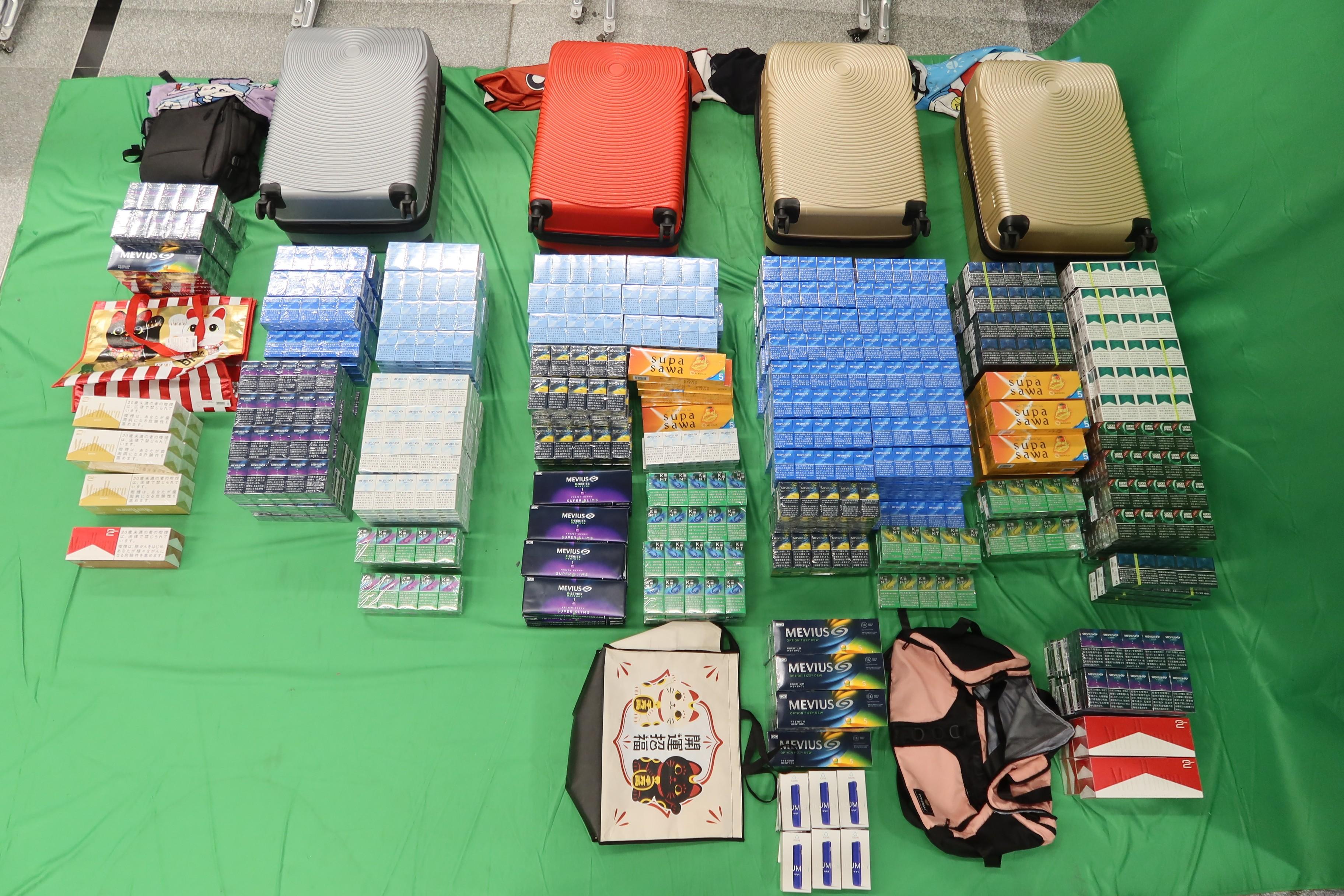 Two incoming passengers were sentenced to seven months&rsquo; imprisonment and fined $500 respectively by the West Kowloon Magistrates' Courts today (February 23) for dealing with duty-not-paid cigarettes, failing to declare them to Customs officers, as well as importing alternative smoking products, in contravention of the Dutiable Commodities Ordinance and the Import and Export Ordinance.  Photo shows the duty-not-paid cigarettes and the alternative smoking products seized from the personal baggage of the two passengers.
