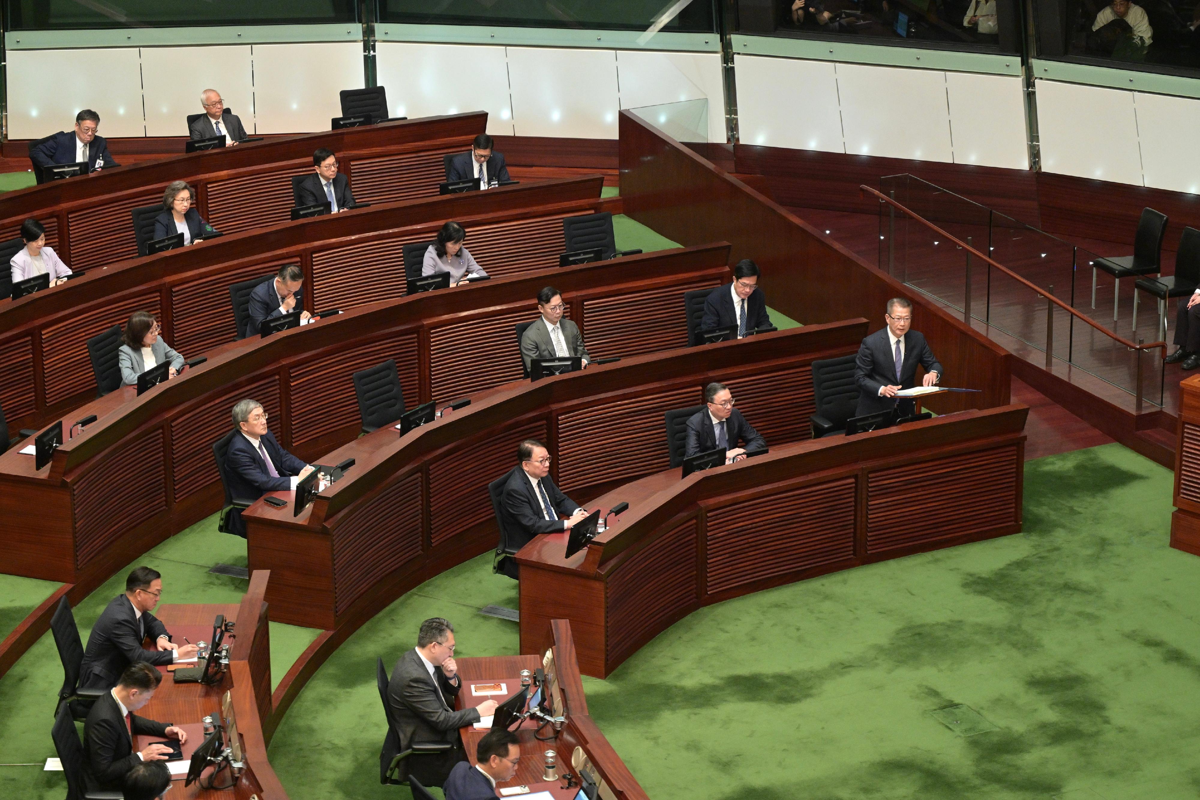 The Financial Secretary, Mr Paul Chan (front row, first right), delivers the 2026-27 Budget in the Legislative Council today (February 25).