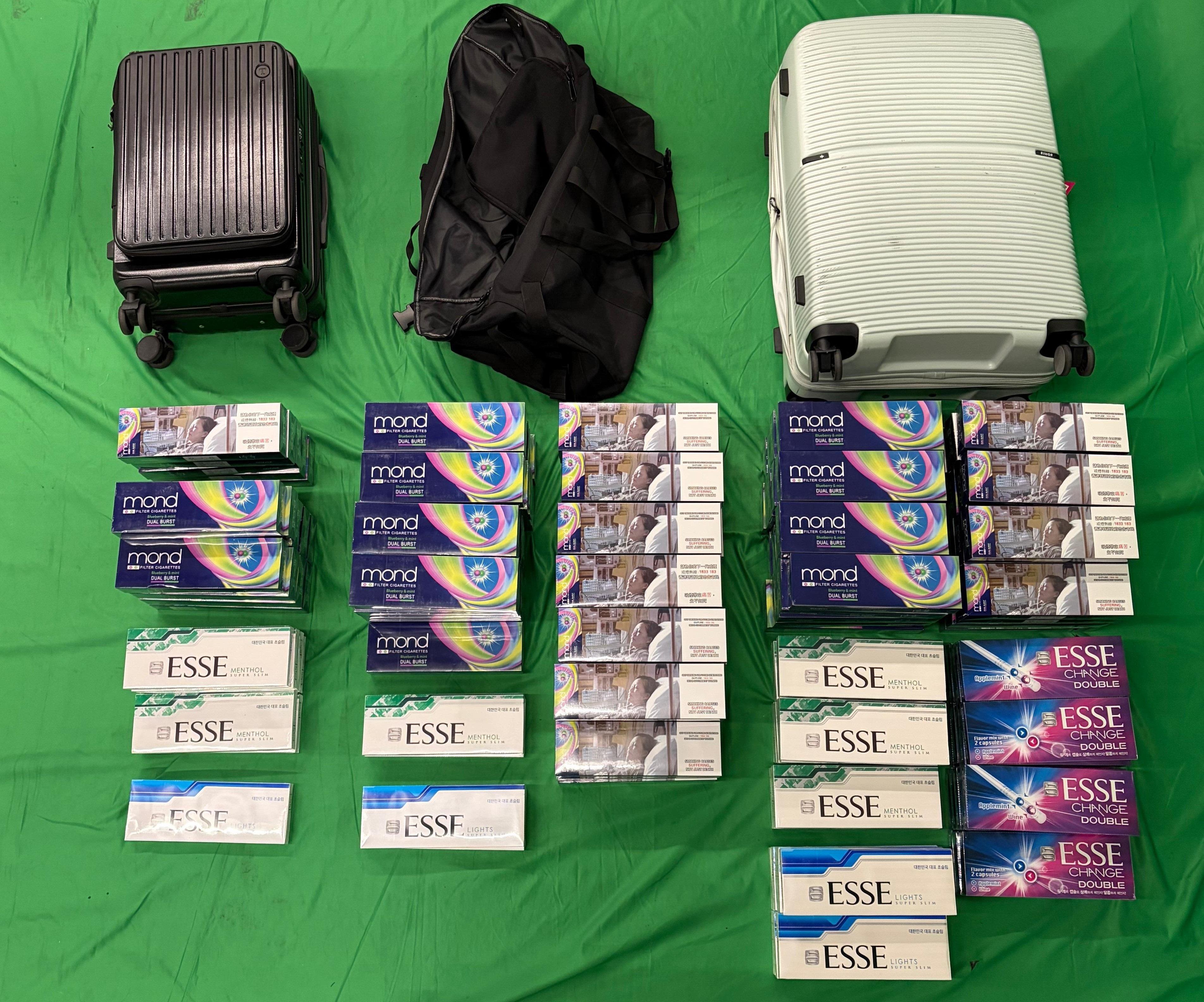 Two incoming passengers were both sentenced to four months' imprisonment and fined $3,000 by the West Kowloon Magistrates' Courts today (February 25) for dealing with and possessing duty-not-paid cigarettes and failing to declare them to Customs officers, in contravention of the Dutiable Commodities Ordinance. Photo shows the duty-not-paid cigarettes seized from the personal baggage of one of the incoming passengers, a 39-year-old female.