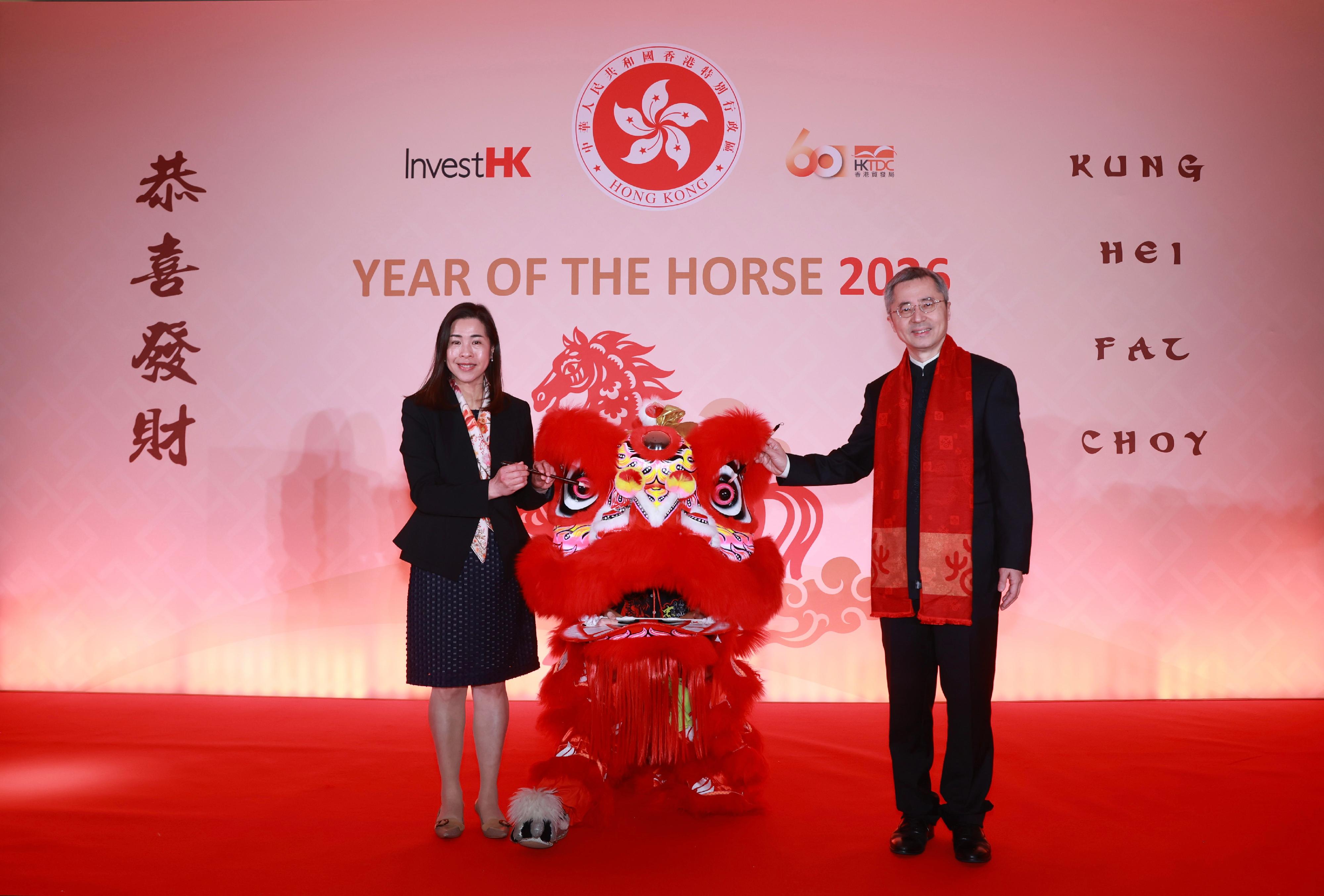 香港駐倫敦經濟貿易辦事處（駐倫敦經貿辦）於二月二十六日（倫敦時間）在倫敦舉行新春酒會慶祝馬年。圖示駐倫敦經貿辦處長周雪梅（左）和中國駐英國使館公使王起（右）在酒會上為舞獅表演進行點睛儀式。