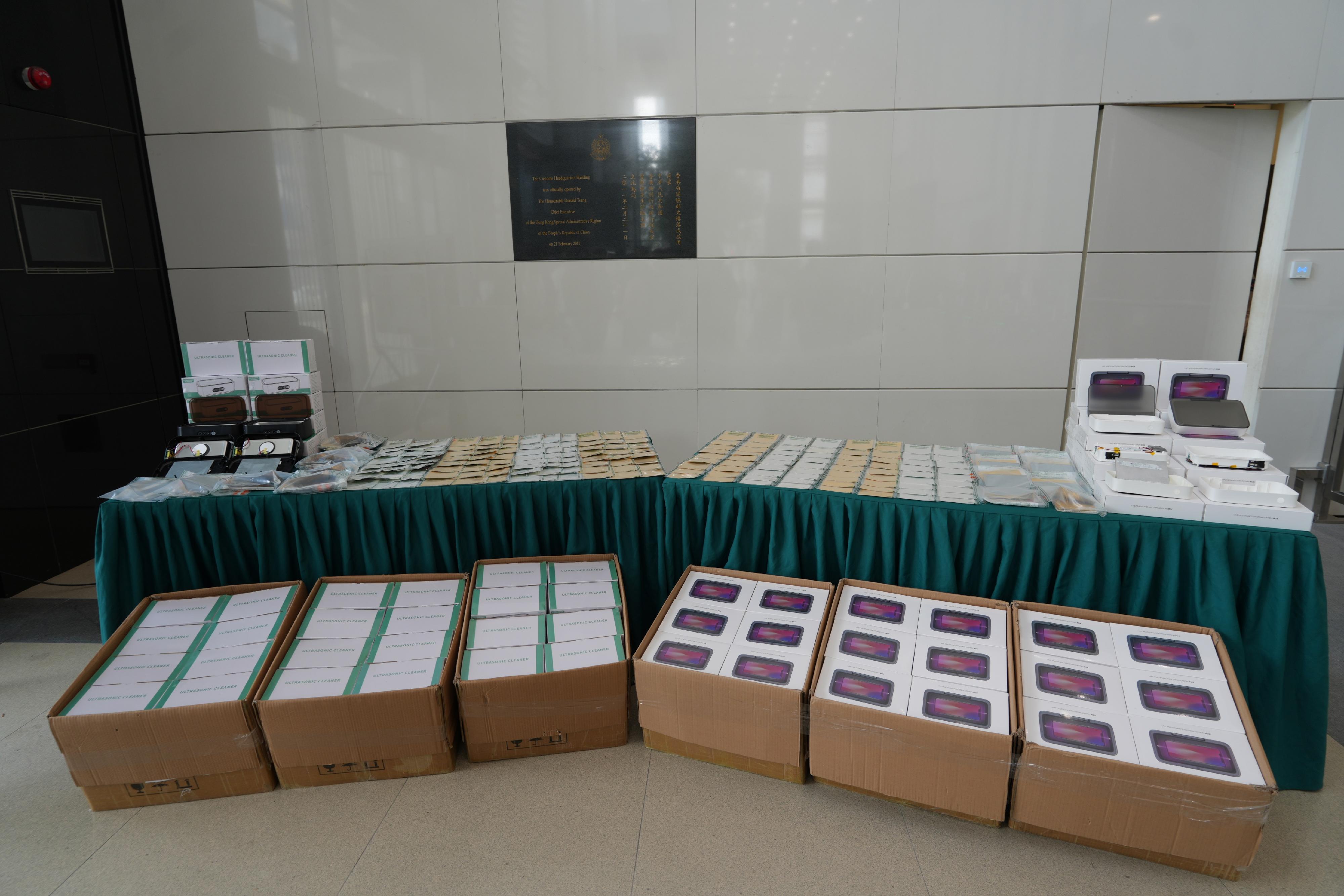 Hong Kong Customs detected two air freight smuggling cases of suspected precious metals on March 2, and seized about 168 kilograms of suspected gold foil and about 285kg of suspected silver foil, with a total estimated market value of about $233 million, at Hong Kong International Airport. Photo shows some of the multifunctional cleaners and UV cleaners used to conceal the suspected precious metals in the case, and some of the precious metals seized. 