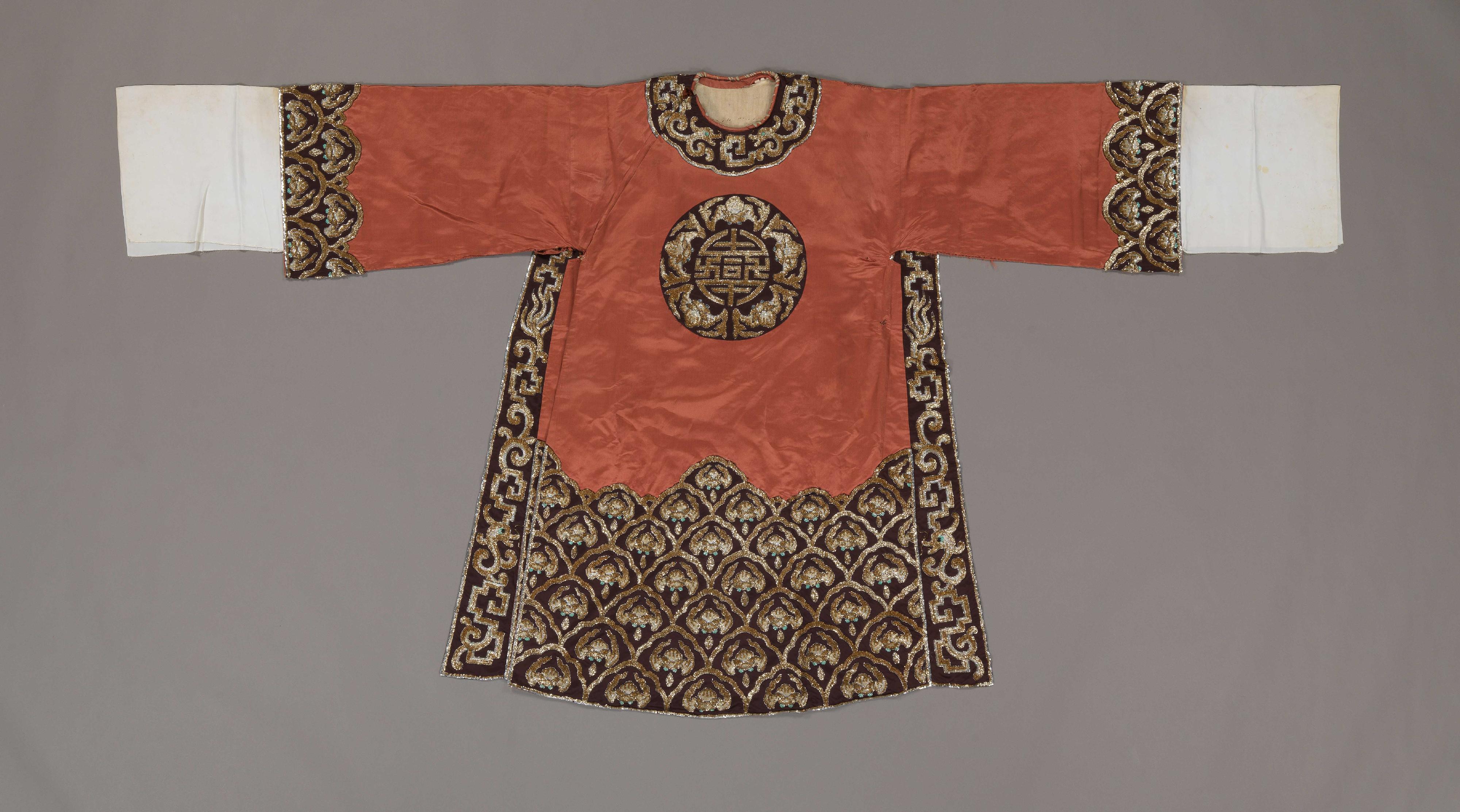 The exhibition "The King of Comic Roles" - Leung Sing Por is on display at the Hong Kong Heritage Museum, showcasing Leung's brilliant artistic journey spanning the realms of Cantonese opera, film and television. Photo shows a brown man's python ceremonial robe with gold and silver sequins worn by Leung.