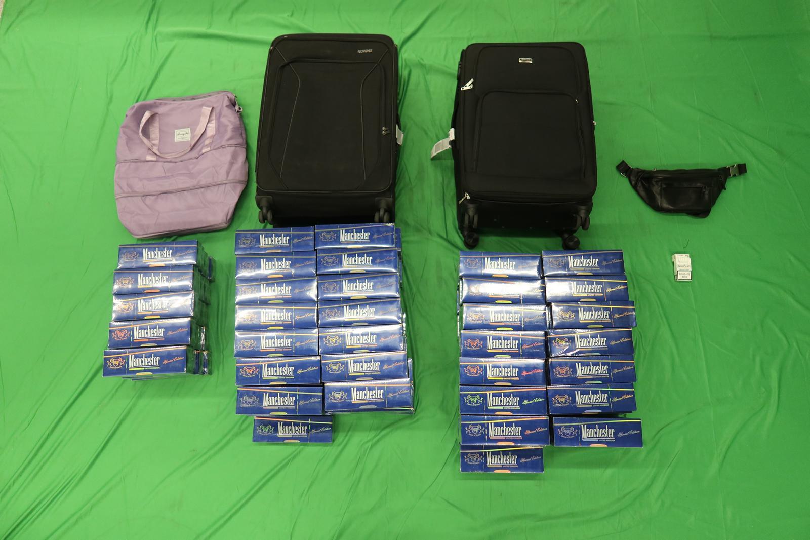 Two incoming passengers were both sentenced to five months' imprisonment and fined $1,000 by the Kowloon City Magistrates' Courts today (March 7) for importing and possessing duty-not-paid cigarettes and failing to declare them to Customs officers, in contravention of the Dutiable Commodities Ordinance. Photo shows the duty-not-paid cigarettes seized from the personal baggage of a 40-year-old incoming passenger.