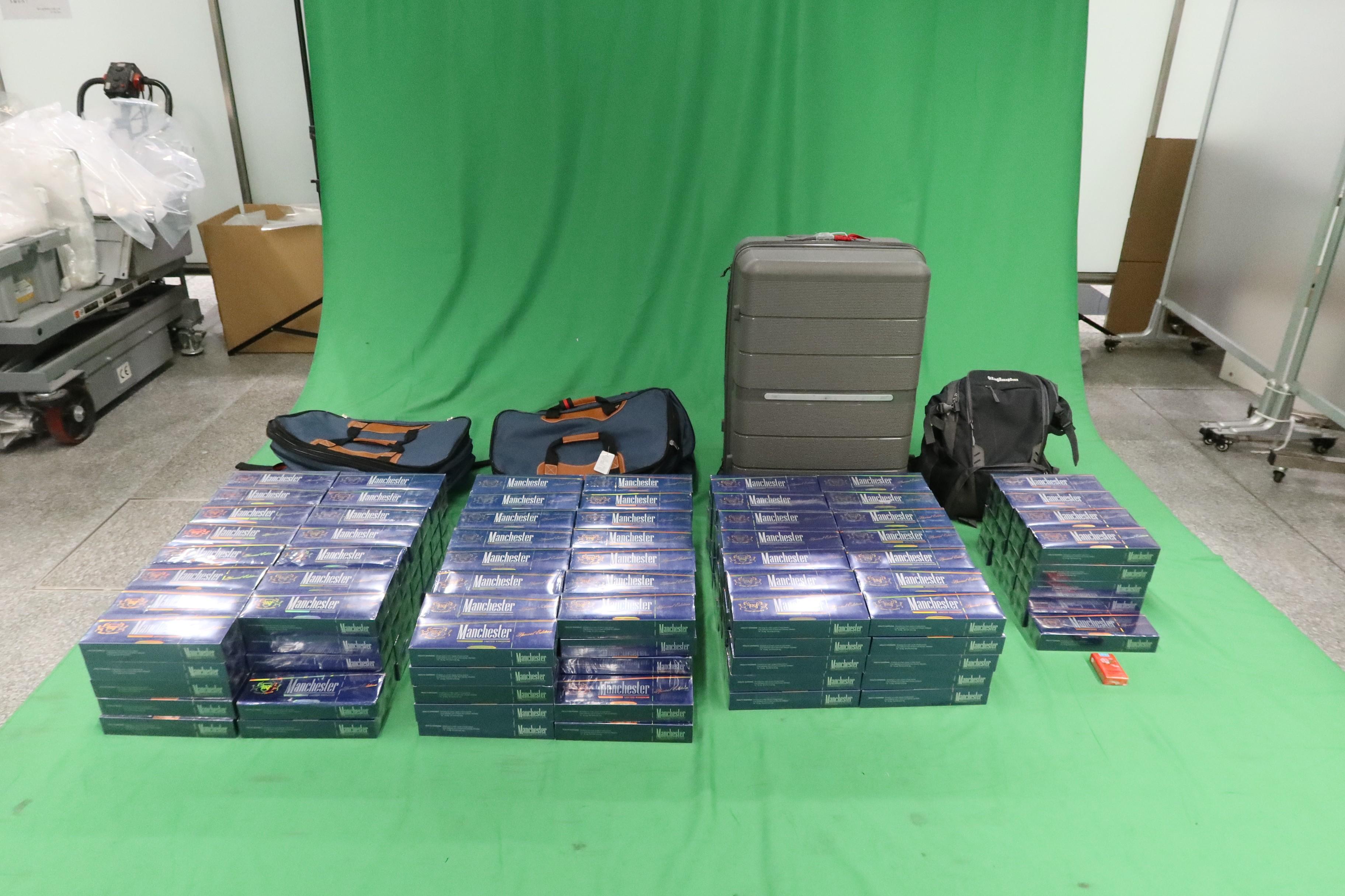 Three incoming passengers were sentenced to six months' imprisonment and fined $900, seven months' imprisonment and fined $1,000, and four months' imprisonment and fined $1,000 respectively by the West Kowloon Magistrates' Courts today (March 9) for importing duty-not-paid cigarettes, failing to declare them to Customs officers, as well as importing alternative smoking products, in contravention of the Dutiable Commodities Ordinance and the Import and Export Ordinance. Photo shows the duty-not-paid cigarettes seized from the personal baggage of a 60-year-old male passenger.