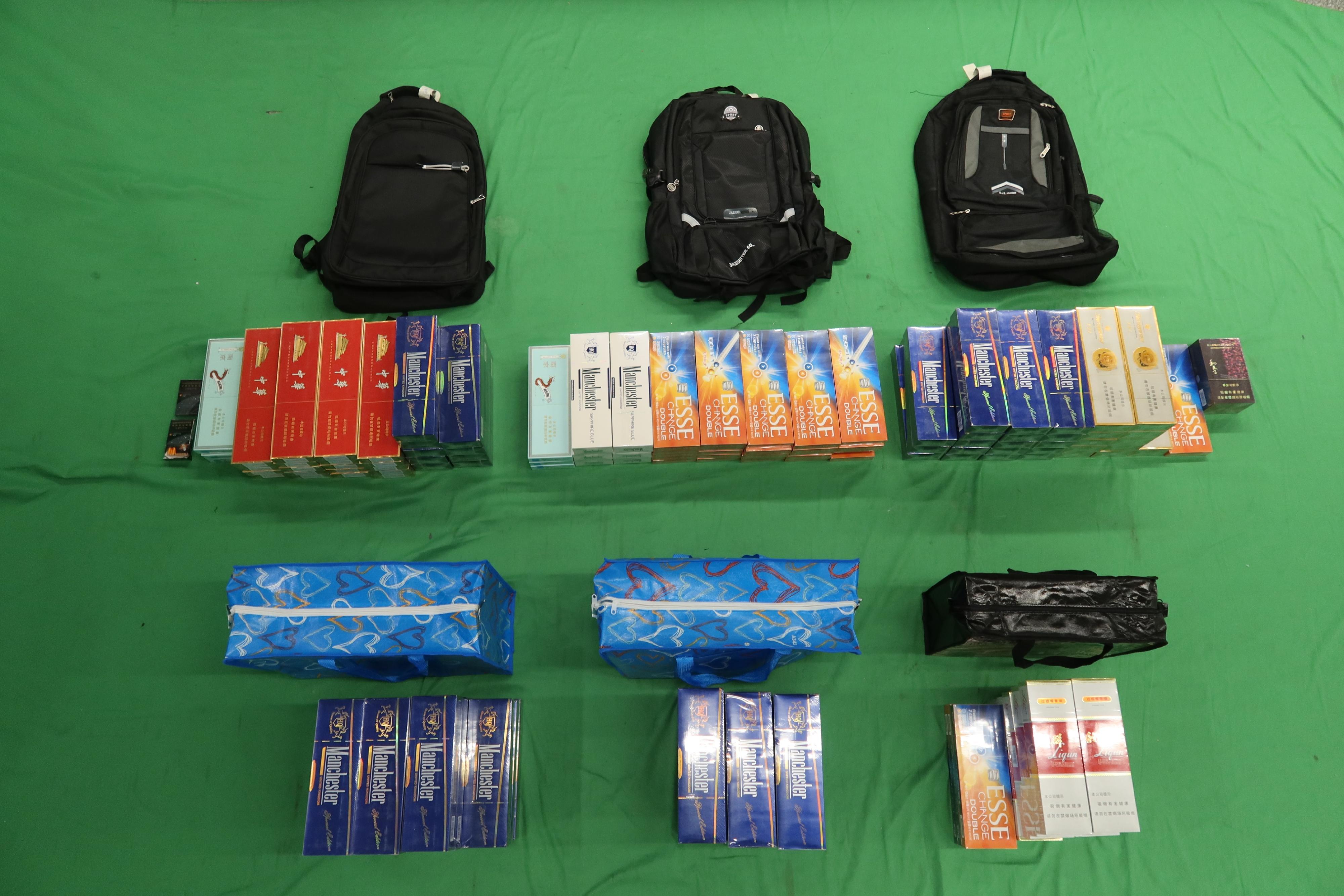 Three incoming passengers were sentenced to six months' imprisonment and fined $900, seven months' imprisonment and fined $1,000, and four months' imprisonment and fined $1,000 respectively by the West Kowloon Magistrates' Courts today (March 9) for importing duty-not-paid cigarettes, failing to declare them to Customs officers, as well as importing alternative smoking products, in contravention of the Dutiable Commodities Ordinance and the Import and Export Ordinance. Photo shows the duty-not-paid cigarettes seized from the personal baggage of a 44-year-old male passenger.