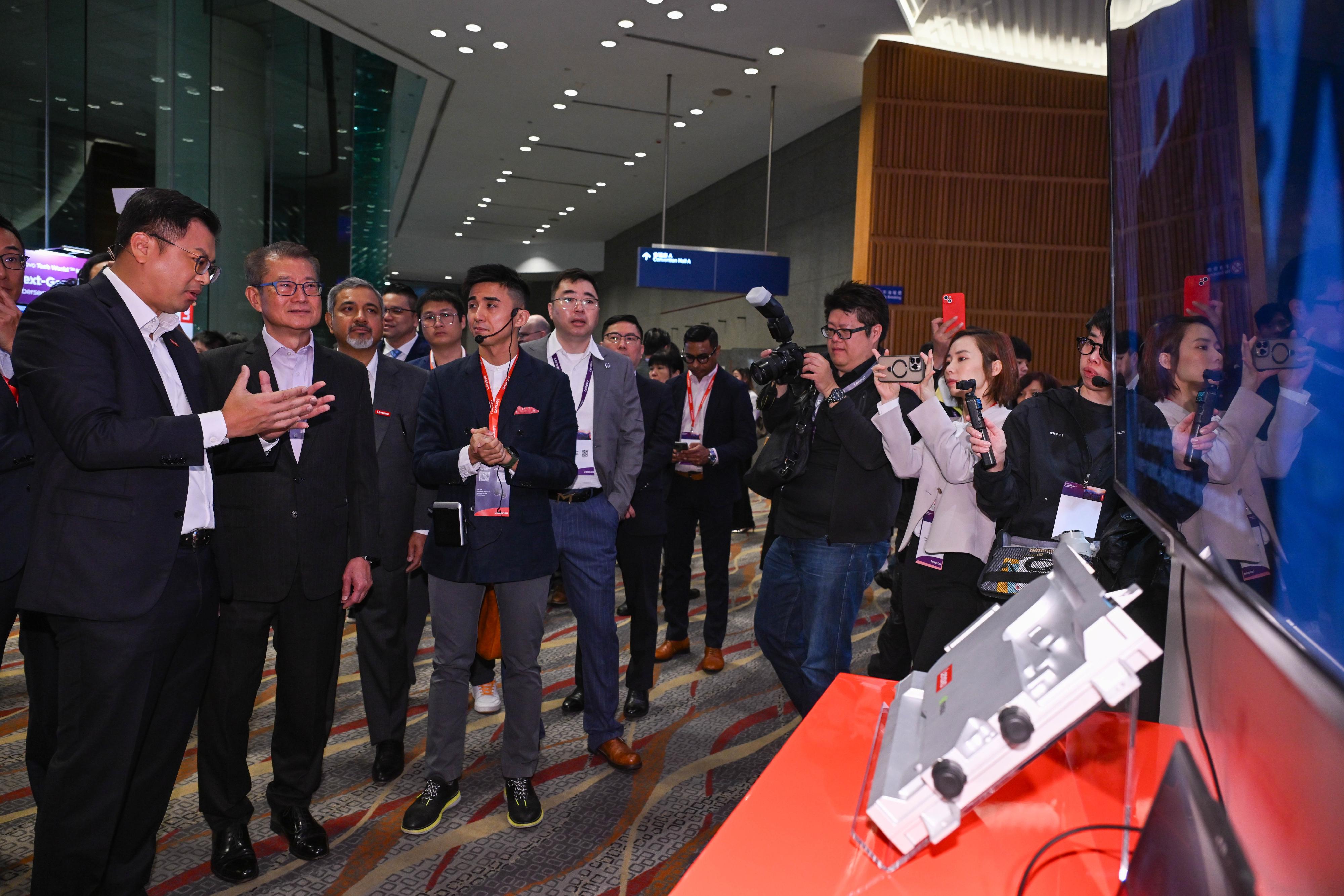The Financial Secretary, Mr Paul Chan, attended the Lenovo Tech World '26 Hong Kong today (March 10). Photo shows Mr Chan (second left) touring an exhibition booth.