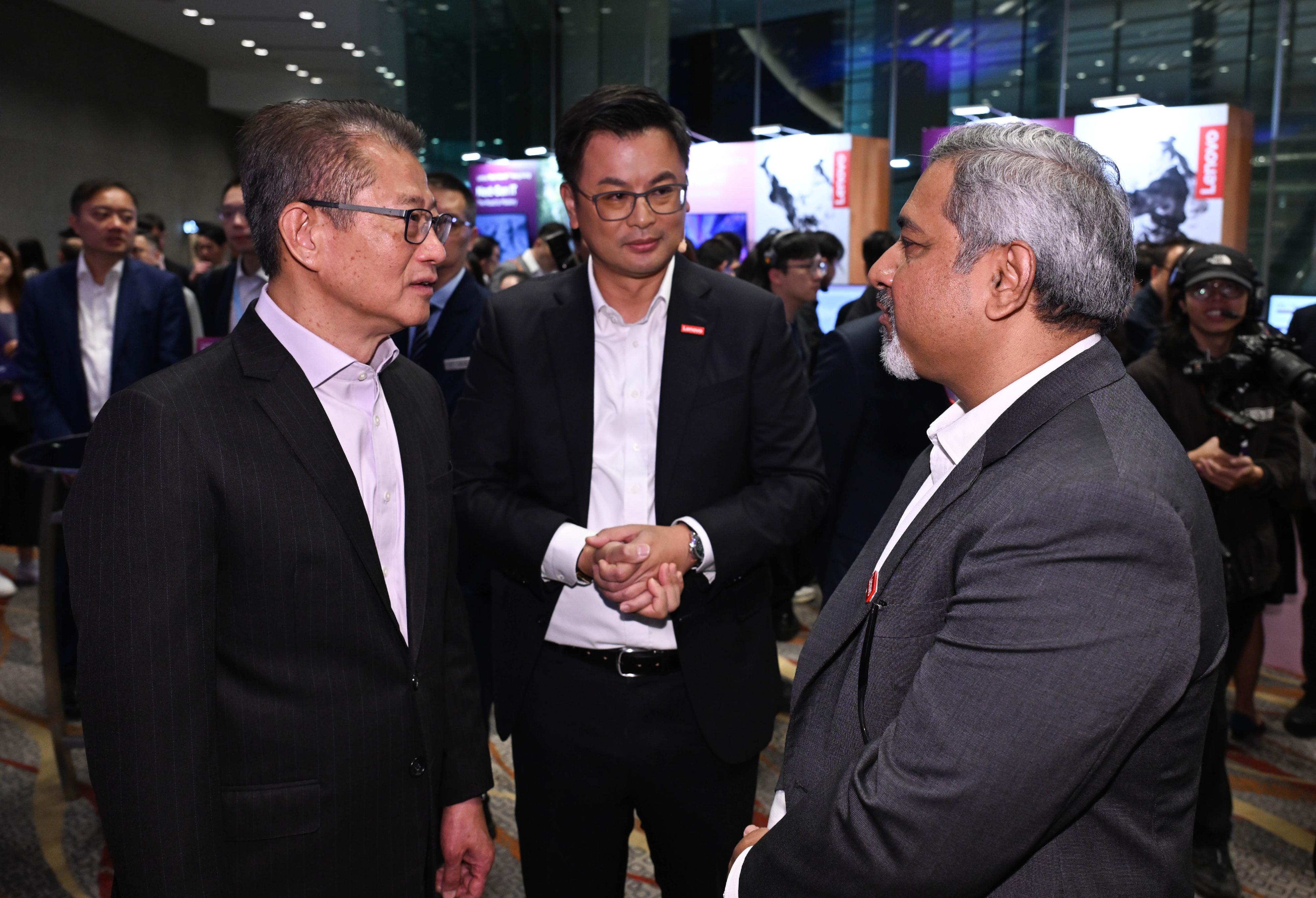 The Financial Secretary, Mr Paul Chan, attended the Lenovo Tech World '26 Hong Kong today (March 10). Photo shows Mr Chan (first left) touring an exhibition booth.