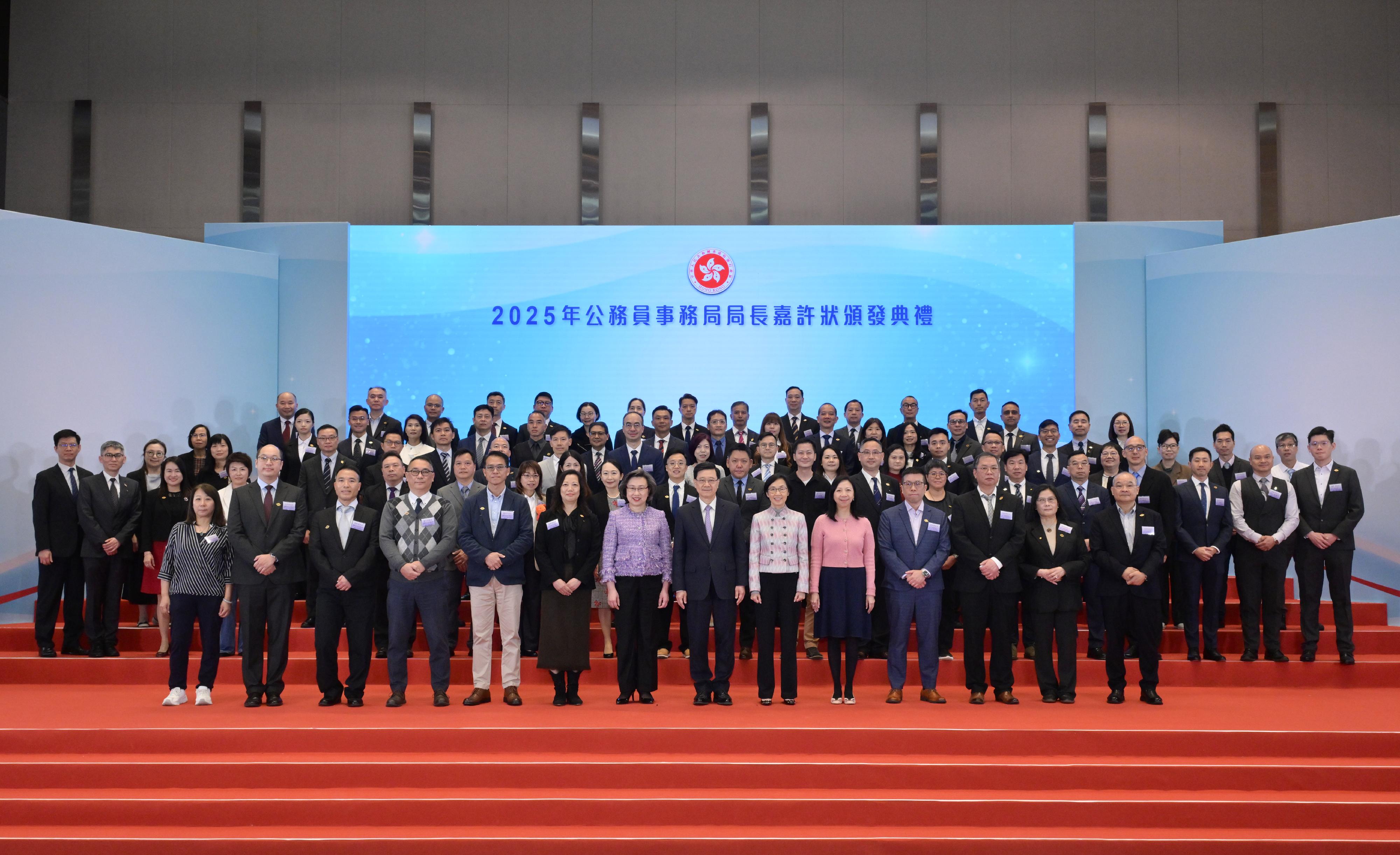 The Chief Executive, Mr John Lee, attended the Secretary for the Civil Service (SCS)'s Commendation Award and Civil Service Volunteer Commendation Award Presentation Ceremony 2025 at the Central Government Offices today (March 12). Photo shows Mr Lee (first row, seventh right); the SCS, Mrs Ingrid Yeung (first row, seventh left); the Chairman of the Public Service Commission, Ms Maisie Cheng (first row, sixth right); and the Permanent Secretary for the Civil Service, Ms Shirley Lam (first row, fifth right), with award recipients of the SCS's Commendation Award Scheme.