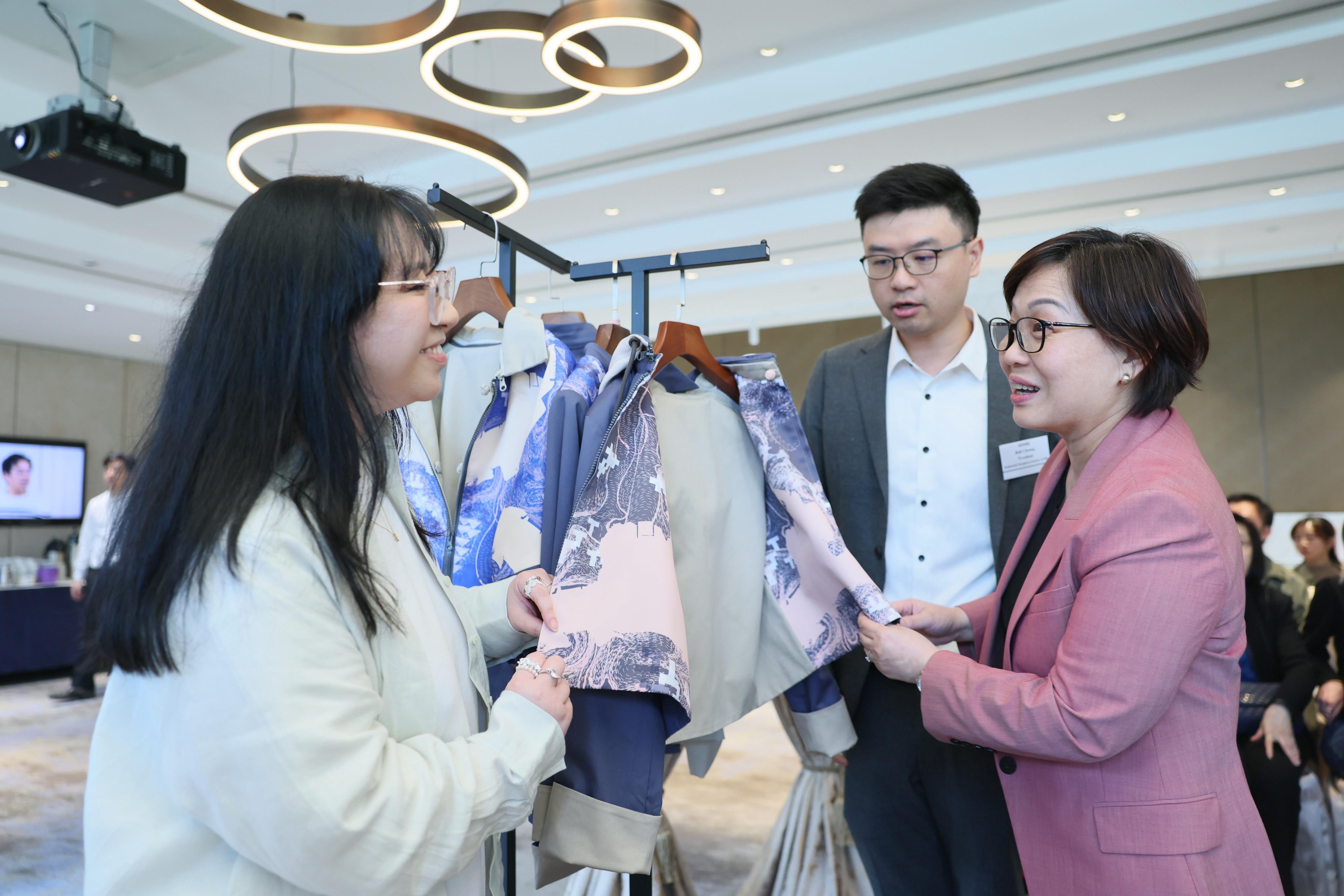 The fourth edition of "ReMIX&middot; Yesterday's Future, Invent Tomorrow!" (ReMIX) Product Launch Ceremony in Hong Kong was held today (March 12) at the Hong Kong Football Club, Happy Valley. Photo shows Assistant Commissioner for Cultural and Creative Industries Miss Yvonne Ip (right) and the President of Industrial Designers Society of Hong Kong, Mr Ball Cheung (centre) viewing the related ReMIX collaborative products.
