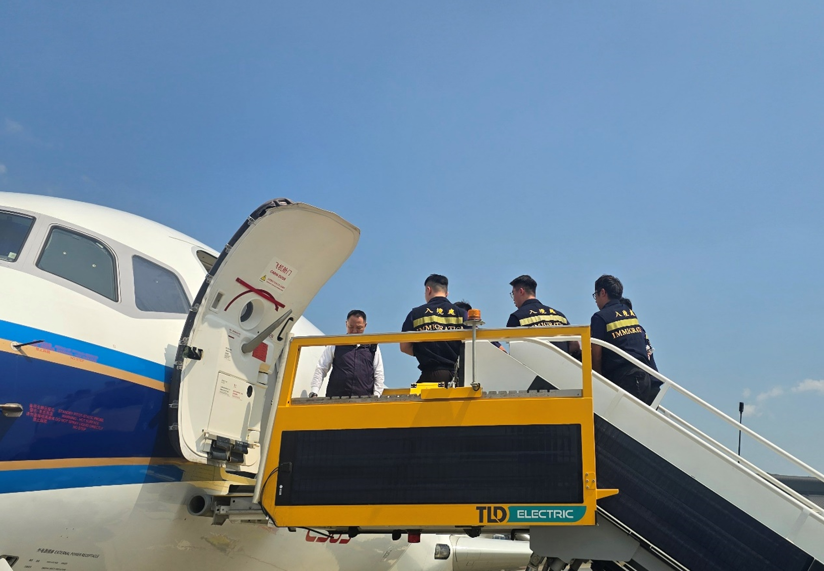 The Immigration Department (ImmD) carried out an in-flight escort repatriation operation codenamed "Expel" yesterday (March 12).  A total of six Pakistani unsubstantiated non-refoulement claimants were repatriated to Pakistan.  Photo shows ImmD officers making final preparations before the take-off of the special chartered flight.